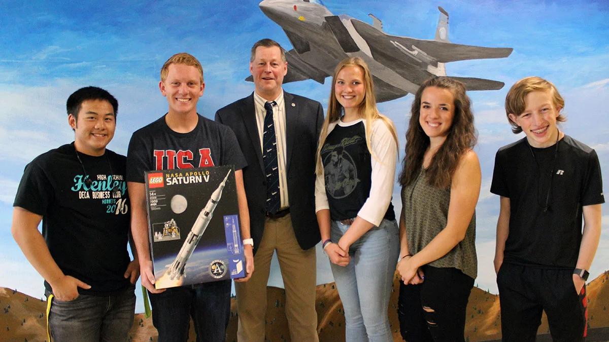 Henley High School engineering students Dylan Huhyn, Thys deHoop, JPLMuseum director James Loftus, Grace Parker, Alyssa Michaelis and MIchael Malineaux pose with a Lego model of the Saturn V rocket donated by Loftus of JPLMuseum.