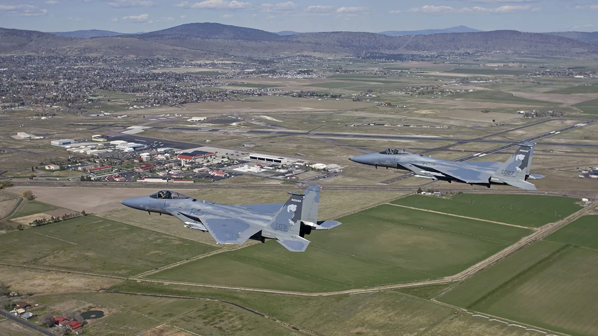 Two F-15 Eagles from the 173rd Fighter Wing out of Kingsley Field fly over Klamath Falls, Oregon during a routine training mission. The 173rd FW is home to the sole F-15C training base for the United States Air Force. (Courtesy photo by Jim Haseltine)
