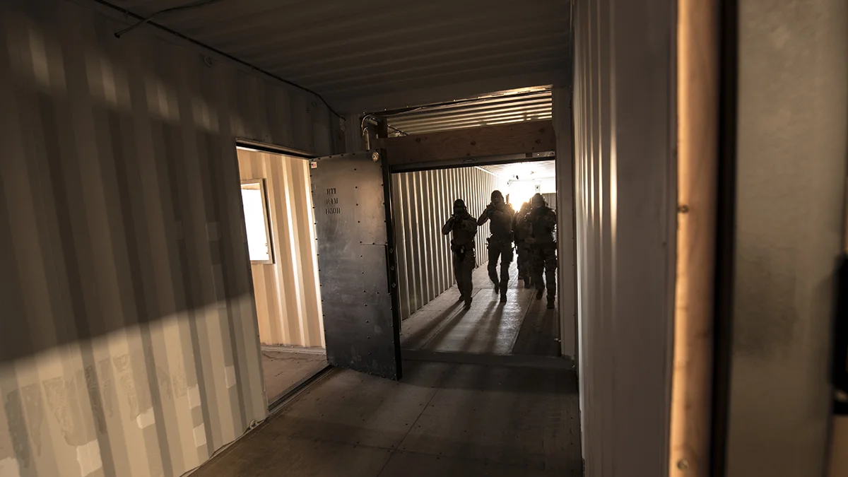 A tactical team hones their skills in entering a hostile building at the newly constructed “shoot house” at Kingsley Field in Klamath Falls, Oregon, during a competition organized for its grand opening, July 24, 2019. The facility is the only one of its kind within a four hour driving radius and represents valuable training for both Airmen and community law enforcement partners. (U.S. Air National Guard photo by Master Sgt. Jefferson Thompson)