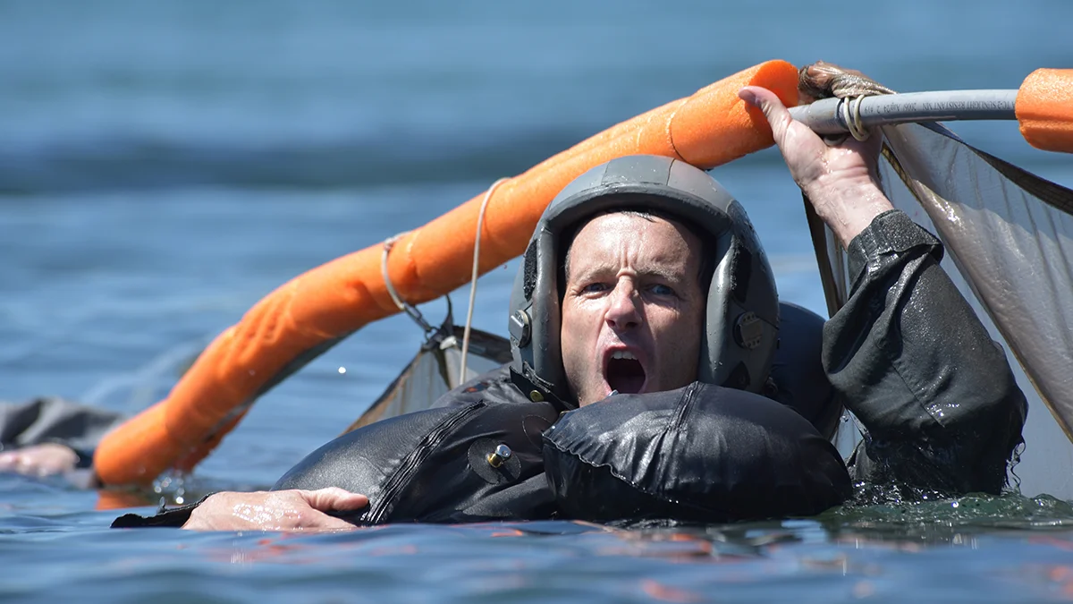 U.S. Air Force Lt. Col. Kedric Osborne, an F-15C Instructor Pilot at the 173rd Fighter Wing, takes a deep breath before submerging beneath a floating parachute canopy during water survival training at Cultus Lake, Oregon, July 25, 2019. Aircrew Flight Equipment hosted the training and was present for all the iterations to ensure participant safety and to ensure participants received the necessary training in the event of an ejection over water. (U.S. Air National Guard photo by Master Sgt. Jefferson Thompson)