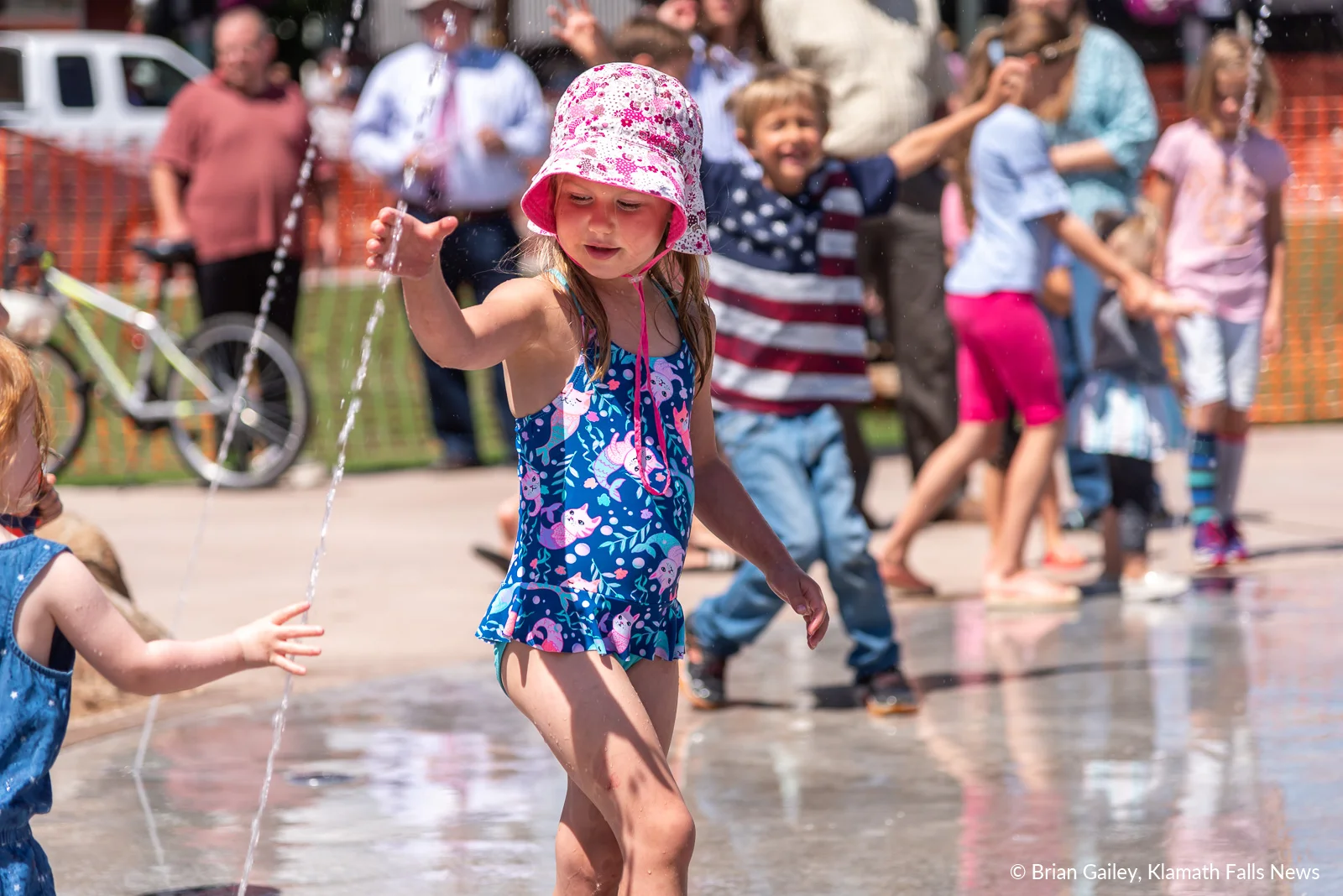 A child plays in the Klamath Commons Splash Pad on opening Day, July 1, 2019 (Image, by Brian Gailey / Klamath Falls News)