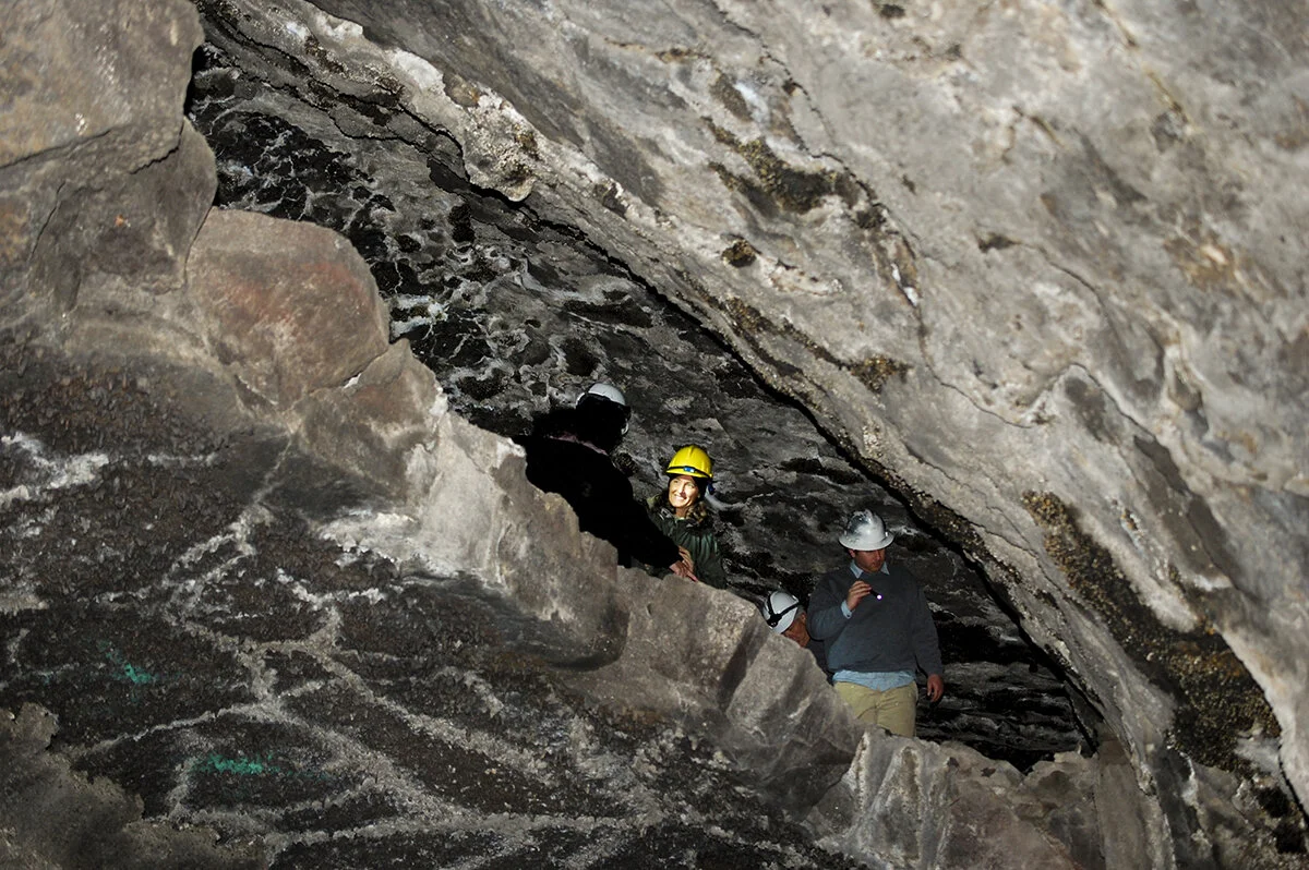 Barnum Cave is one of the many lava tube formations that lie just under the pine-juniper covered landscape in rural Siskiyou County. Each cave has unique features such as large chambers, small grottos and this upper level alcove that reflect the geologic timeline of the area. Credit: Jennifer Jones/USFWS