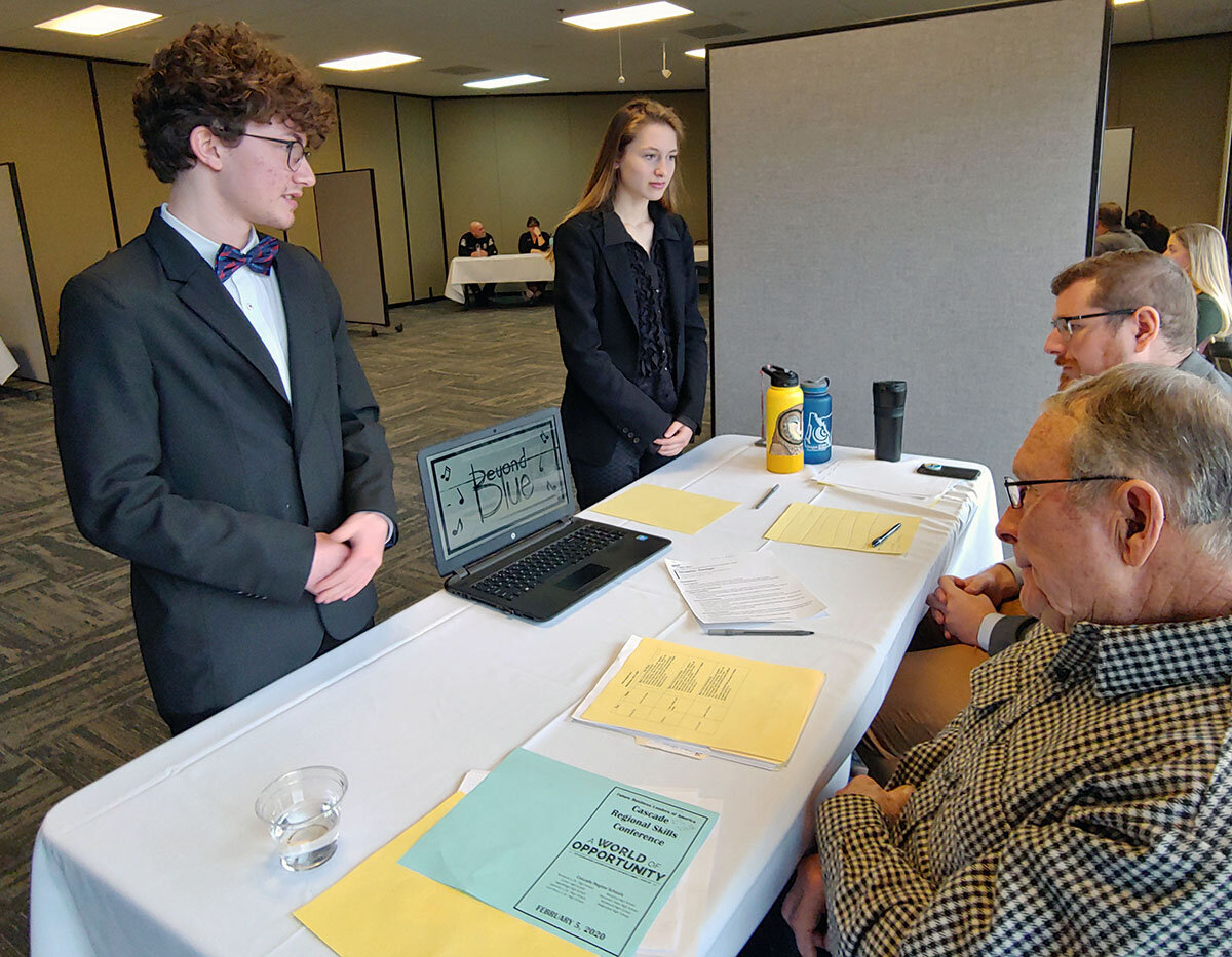  Bonanza senior Cassidy Byrne and his sister, sophomore Charlize Byrne, competing in the graphic design category, present their project – promotional materials for a band they named Beyond Blue – before judges at the 2020 FBLA Cascade Regional Skills