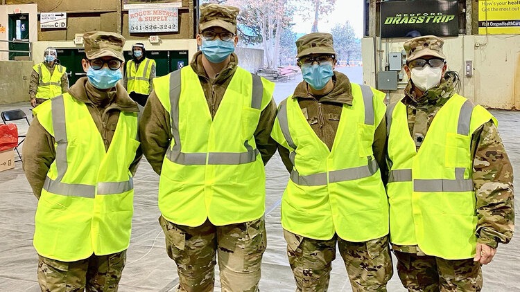 Volunteer Airmen from the 173rd Fighter Wing prepare to assist at a drive through COVID-19 vaccine clinic in Medford, Oregon January 22, 2021. Twelve Airmen from Kingsley Field are on State Active Duty as part of Task Force Guardian supporting COVID-19 vaccine clinics in Southern Oregon. (U.S. Air National Guard Courtesy photo)