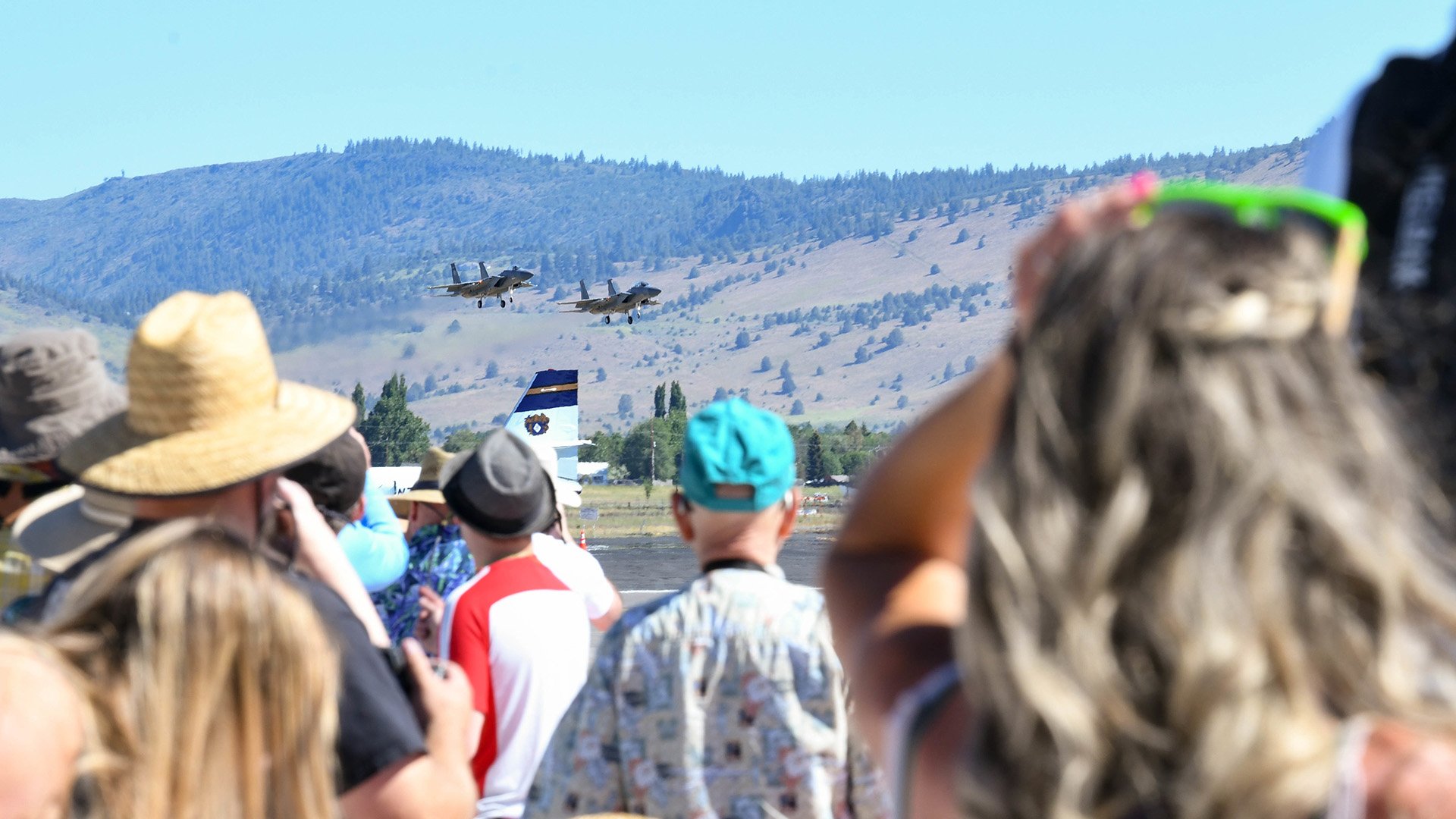  Guests watch inbound F-15s from the 173rd Fighter Wing, during the Sentry Eagle Open House June 24, 2022, at Kingsley Field in Klamath Falls, Ore. The open house allowed Kingsley Field to provide a behind-the-scenes look at the F-15 training mission