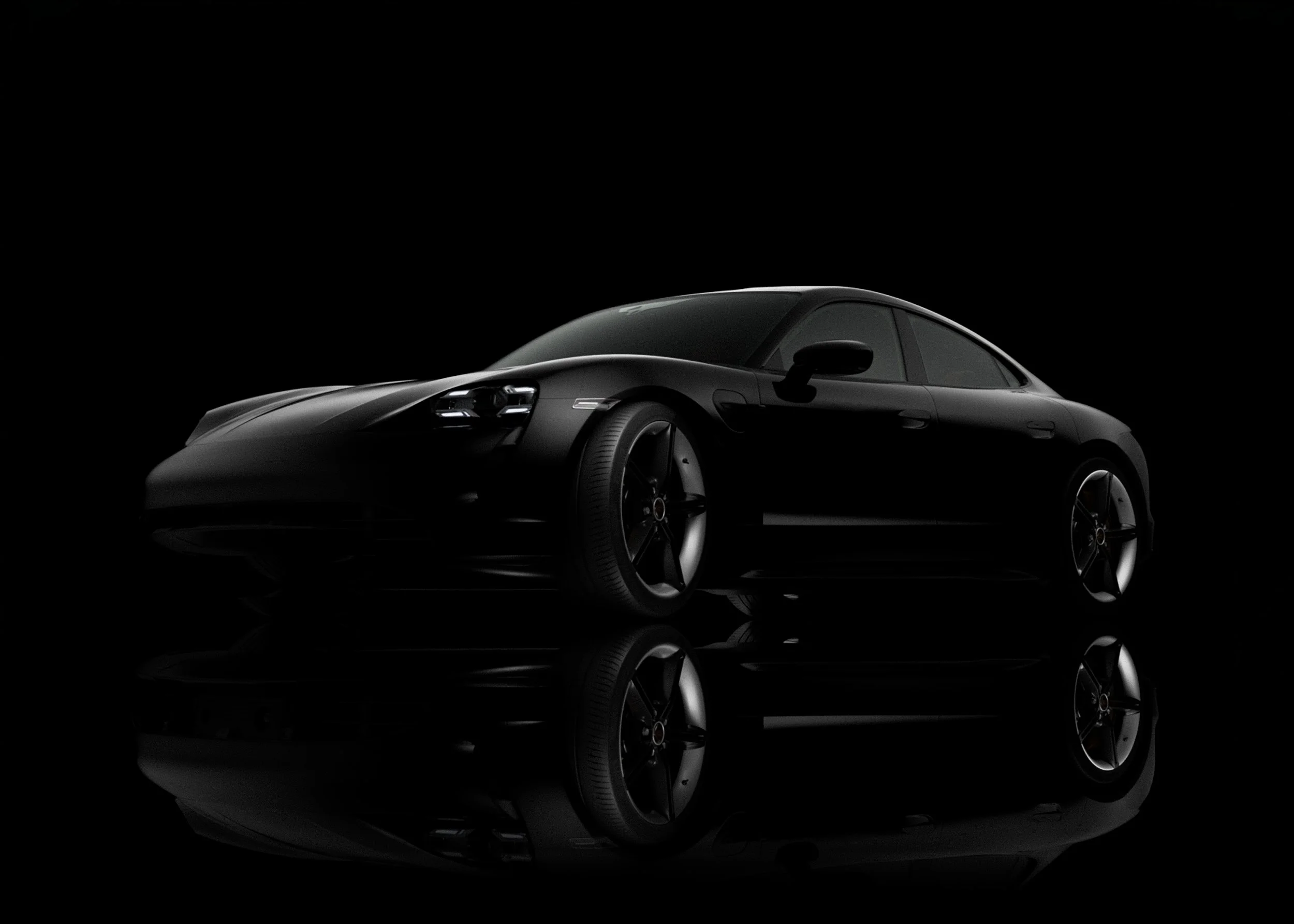 A sleek black sports car with curved lines and shiny surfaces, positioned against a black background with a reflective surface beneath it.