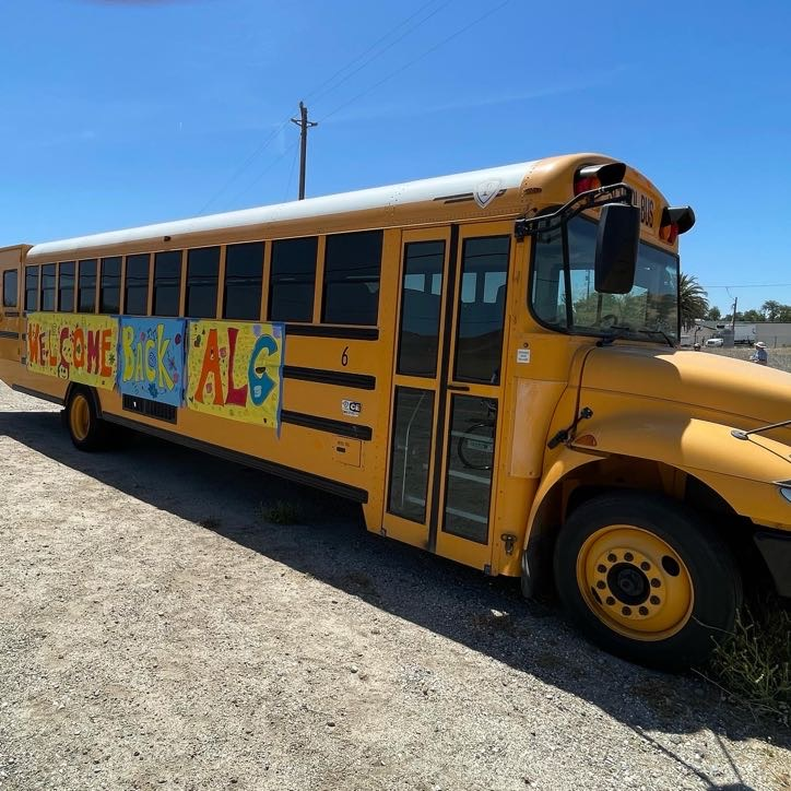 school buss with welcome back ALC painted on it