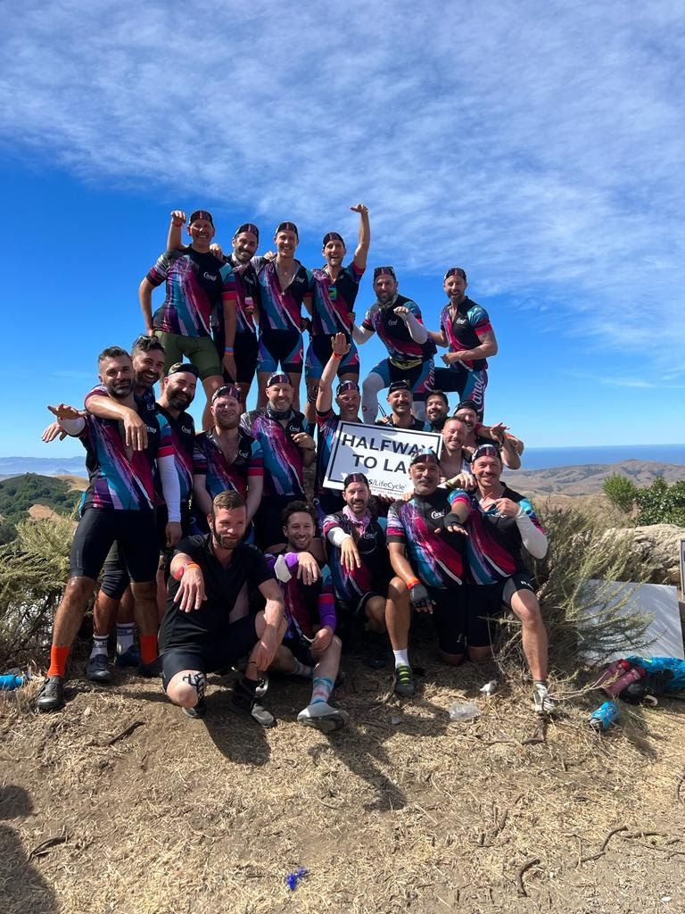 The Carols team of 20 holding sign half way to LA