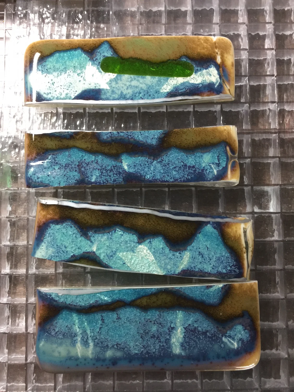 I then determine what size stones I need for my jewelry and begin to cut the glass down to size using a glass cutter and commercial breaking pliers. Here I have cut strips to form the vertical dimensions of the cabochon.
