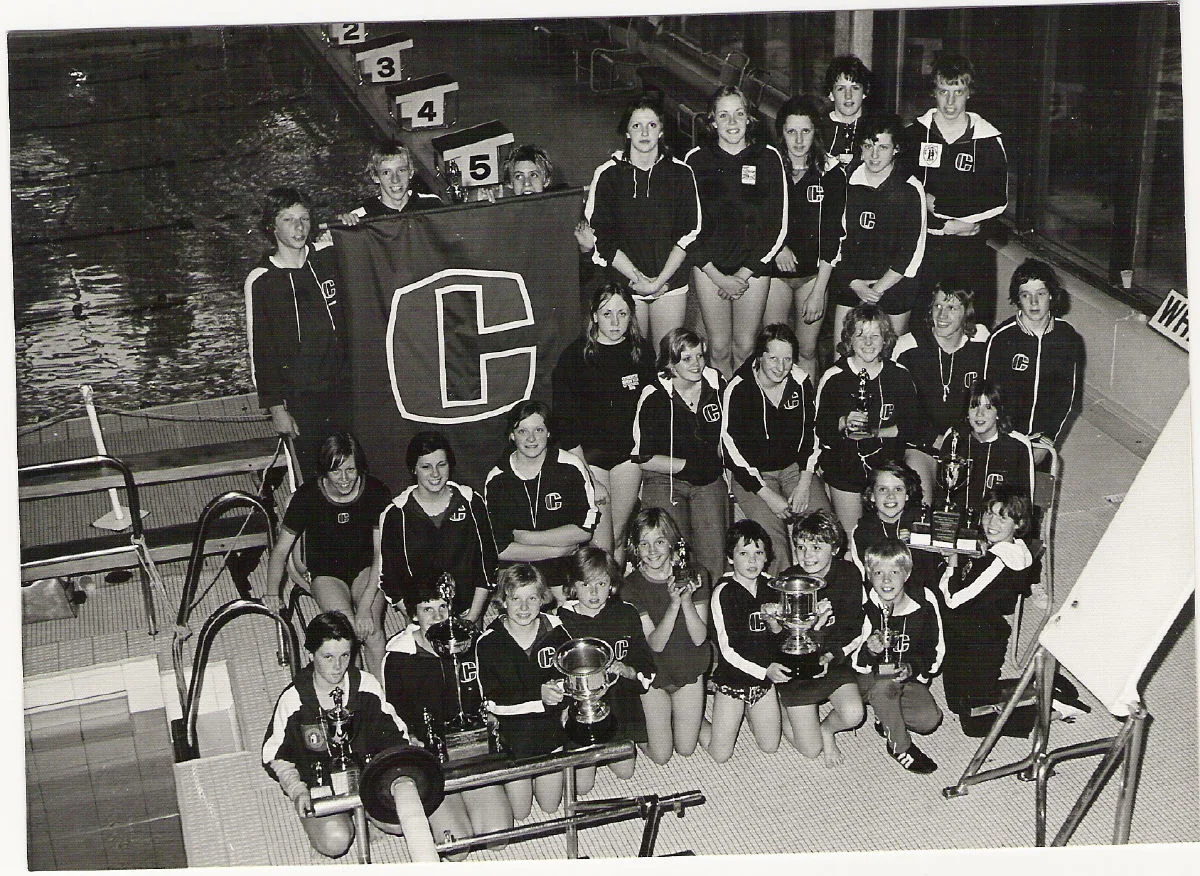 That's me with the curly hair and a silly grin on the front row holding a trophy in 1976 (aged 11) at Coventry Swimming Club