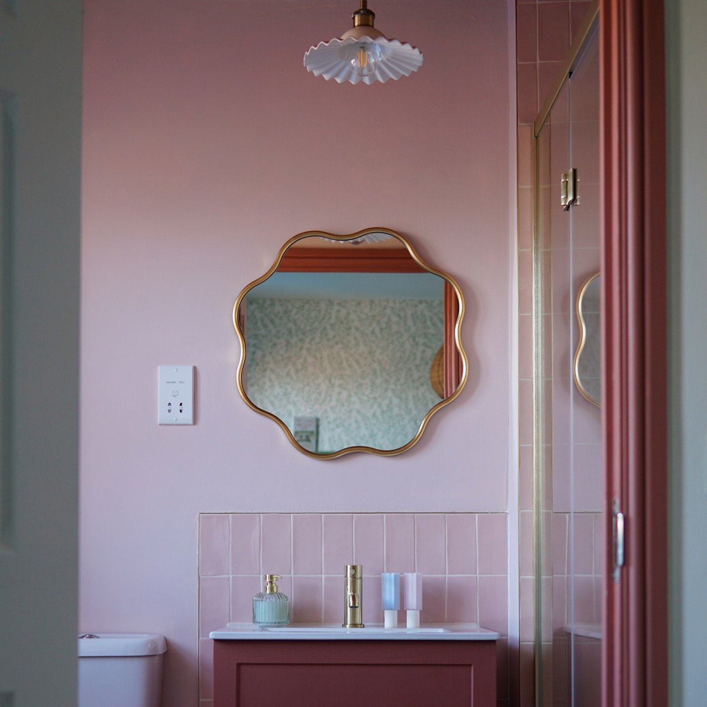 A look inside @tahirashome&rsquo;s bathroom, using @firedearthuk&rsquo;s Forecast Lundy Rectangle tiles across the sink splashback and in the shower. The soft pink adds to the warm monochromatic colour scheme and shows how tiles can be used in smalle
