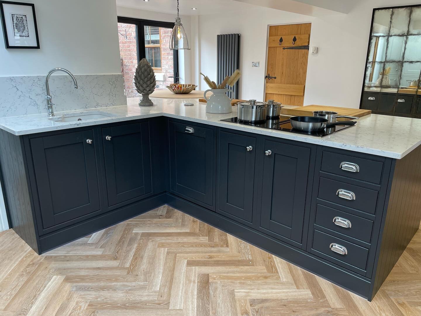 Black and Pearl Grey complement each other perfectly in this recently finished @lauraashleyfittedfurniture Helmsley kitchen, paired here with @karndean_uk Pale Limed Oak Herringbone Flooring and @caesarstone_uk White Attica Quartz Worktops to create 