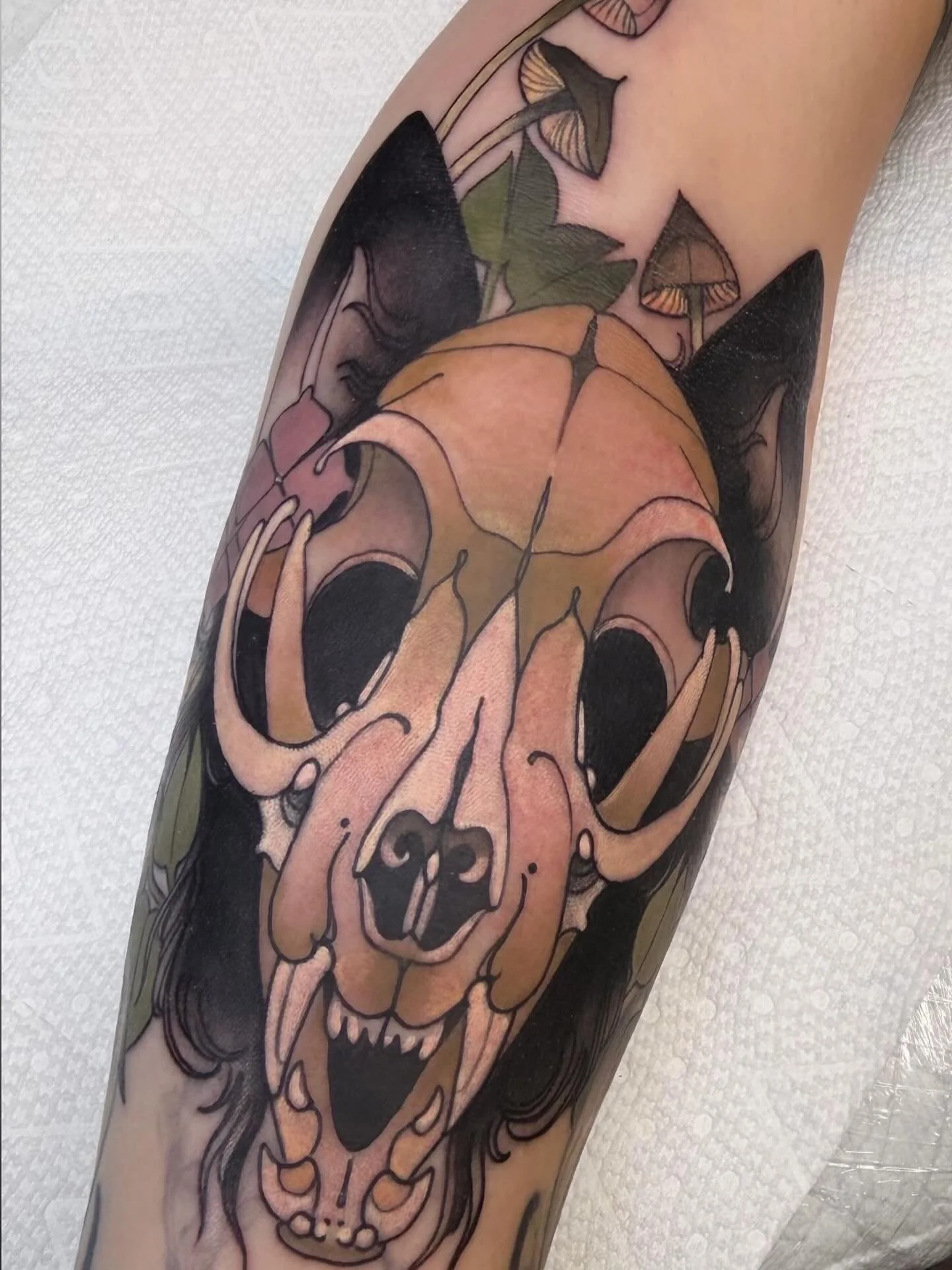 Cat skull tattoo with mushrooms and flowers by Gia Rose