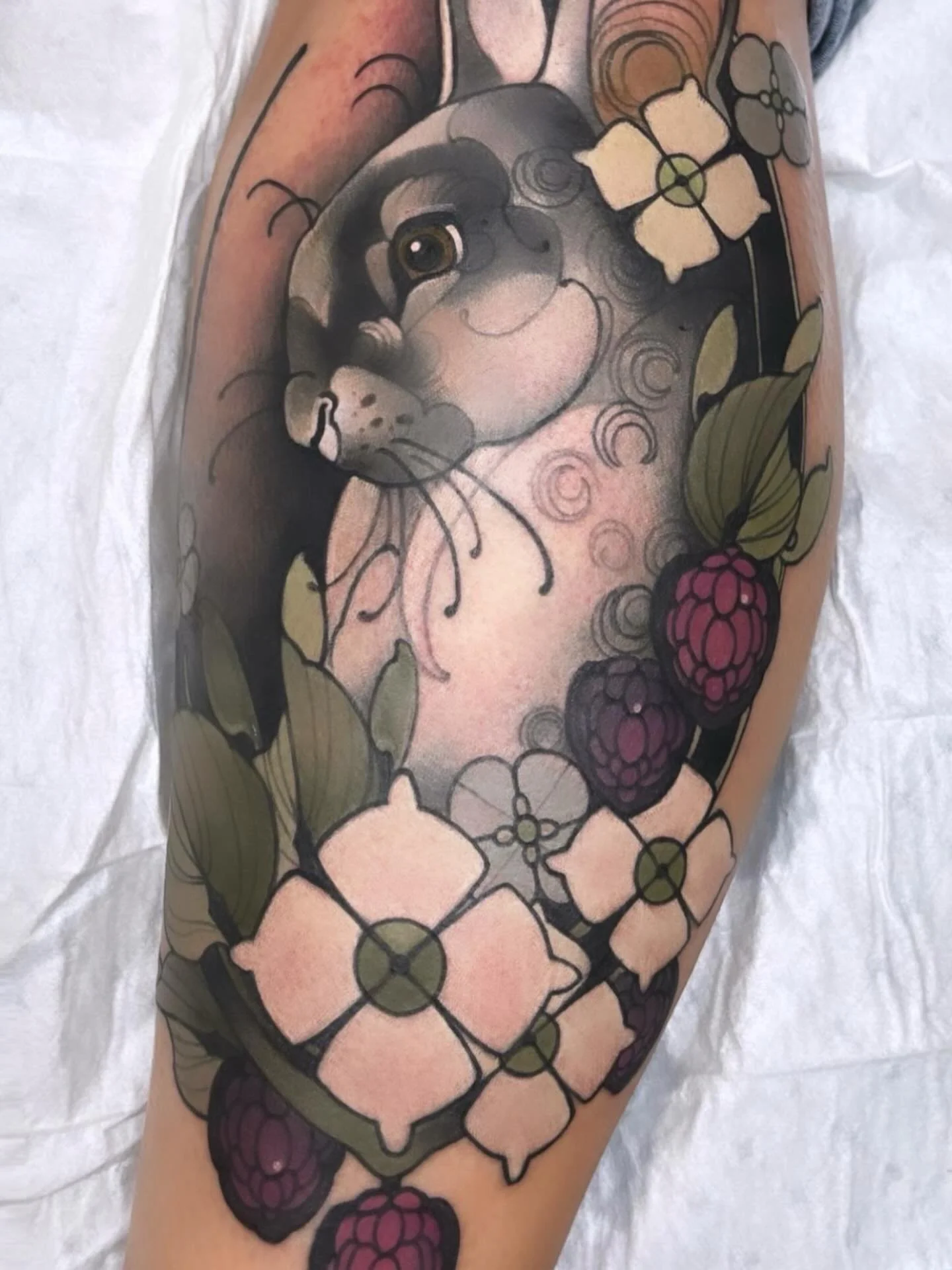 Rabbit tattoo with flowers by Gia Rose