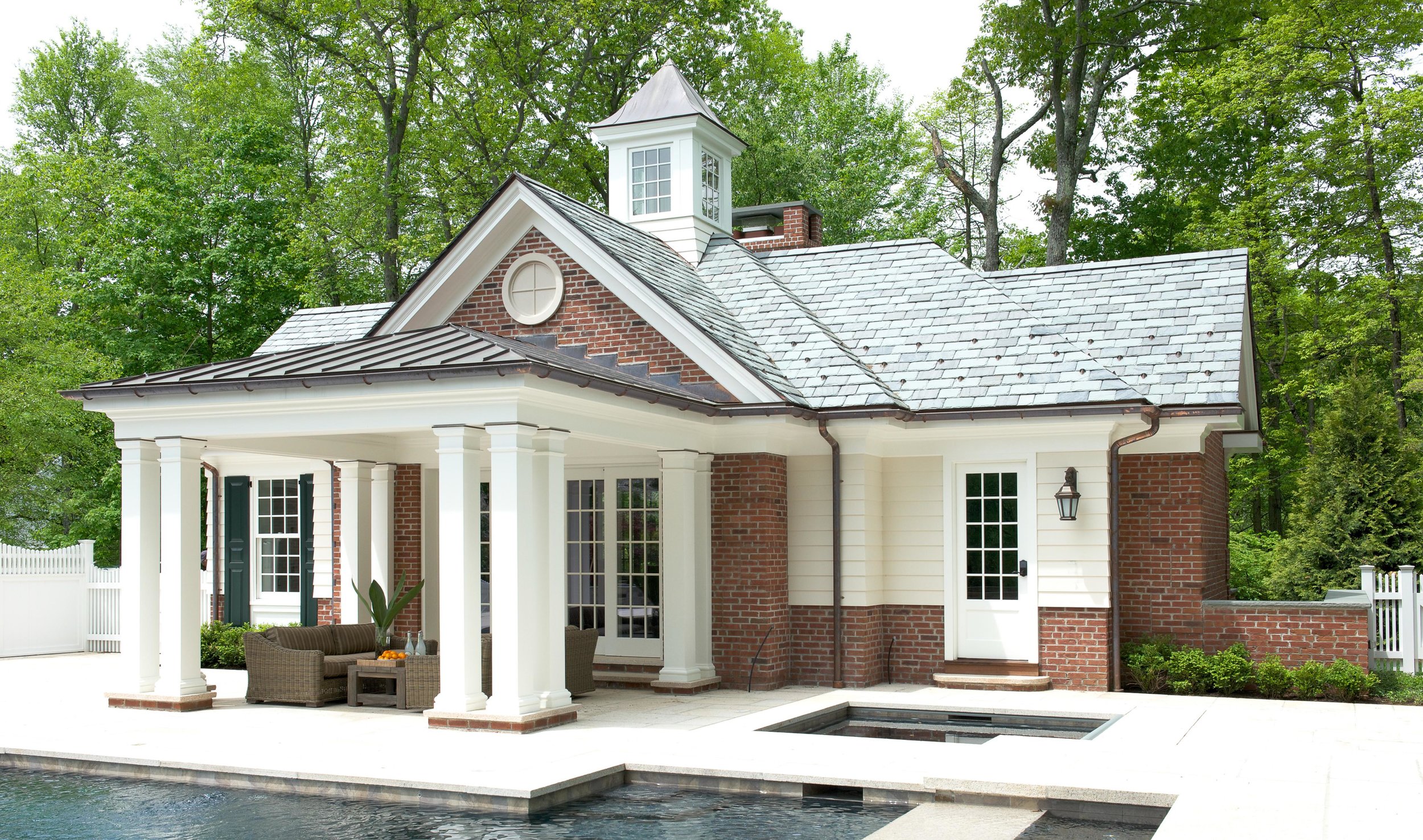 Brick pool house with slate and copper roof