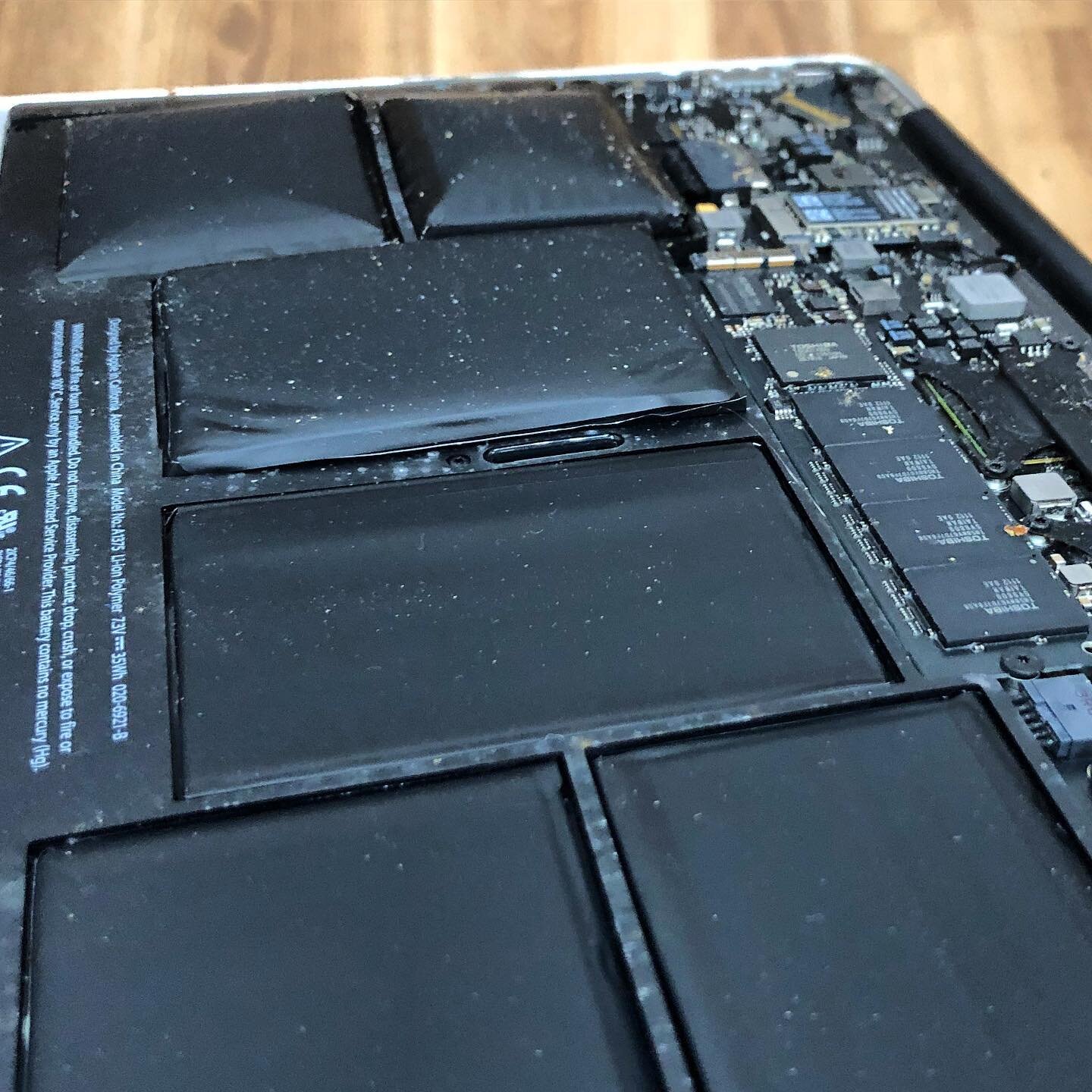 Those big pillows are the result of a neglected battery change. This MacBook Air was impossible to use because the battery was pushing so hard on the top case. A new battery and this computer was as good as new. #rocketrepair
