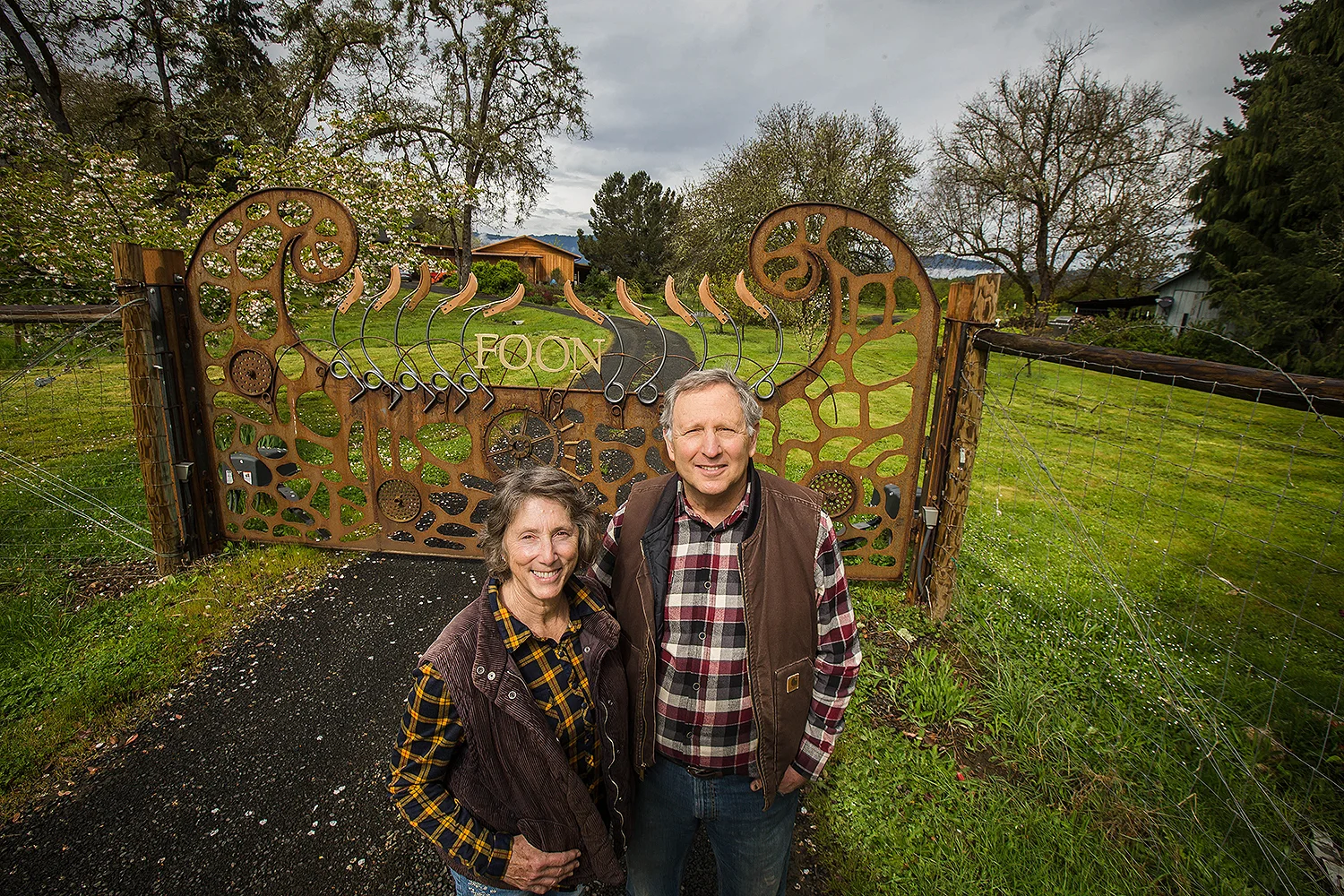 Dr. Howard and Marjorie Feldman in front of the ornate entry gate he designed and fabricated.