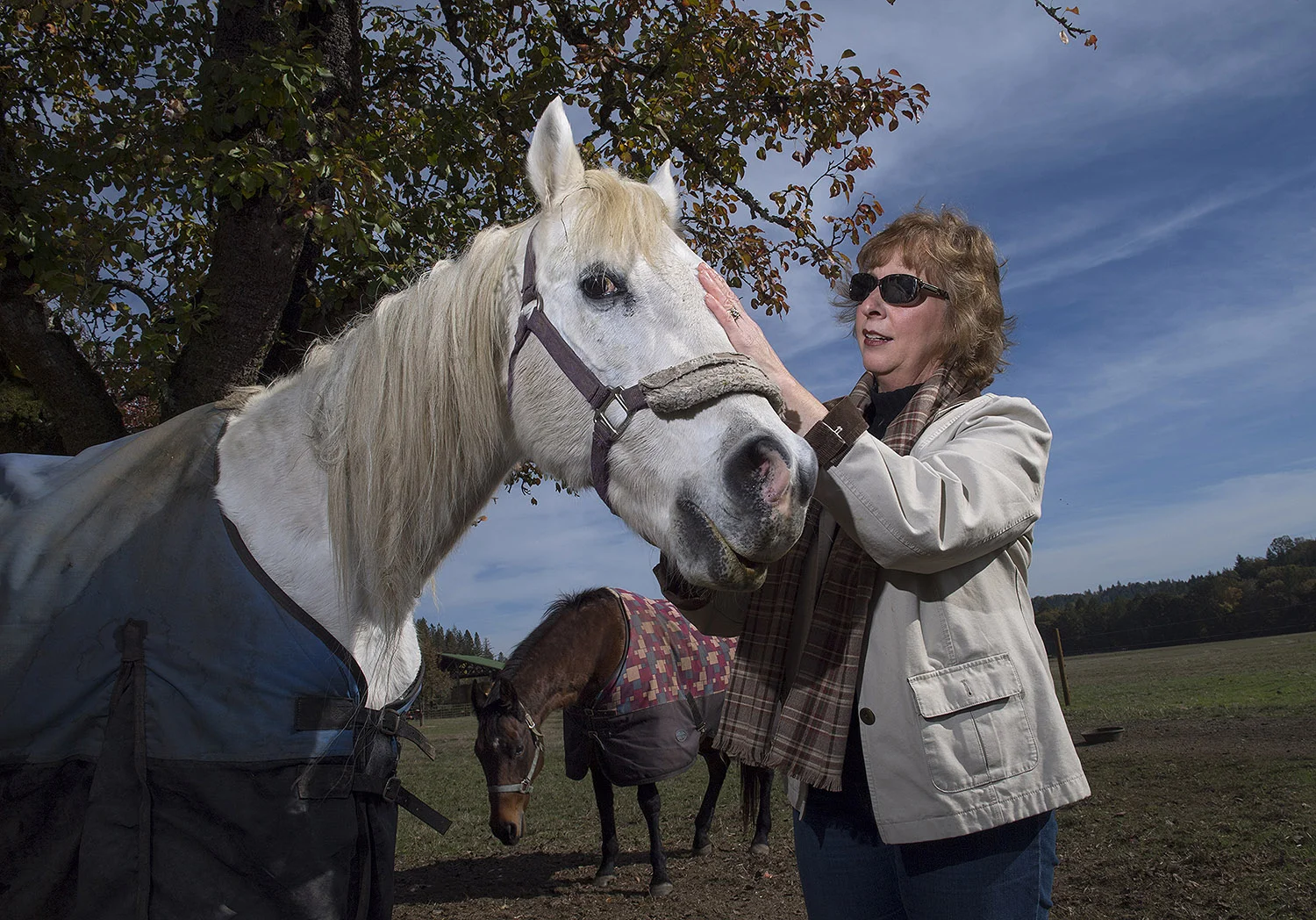 Optometrist Bonnie Gauer with a friend on her family's property.