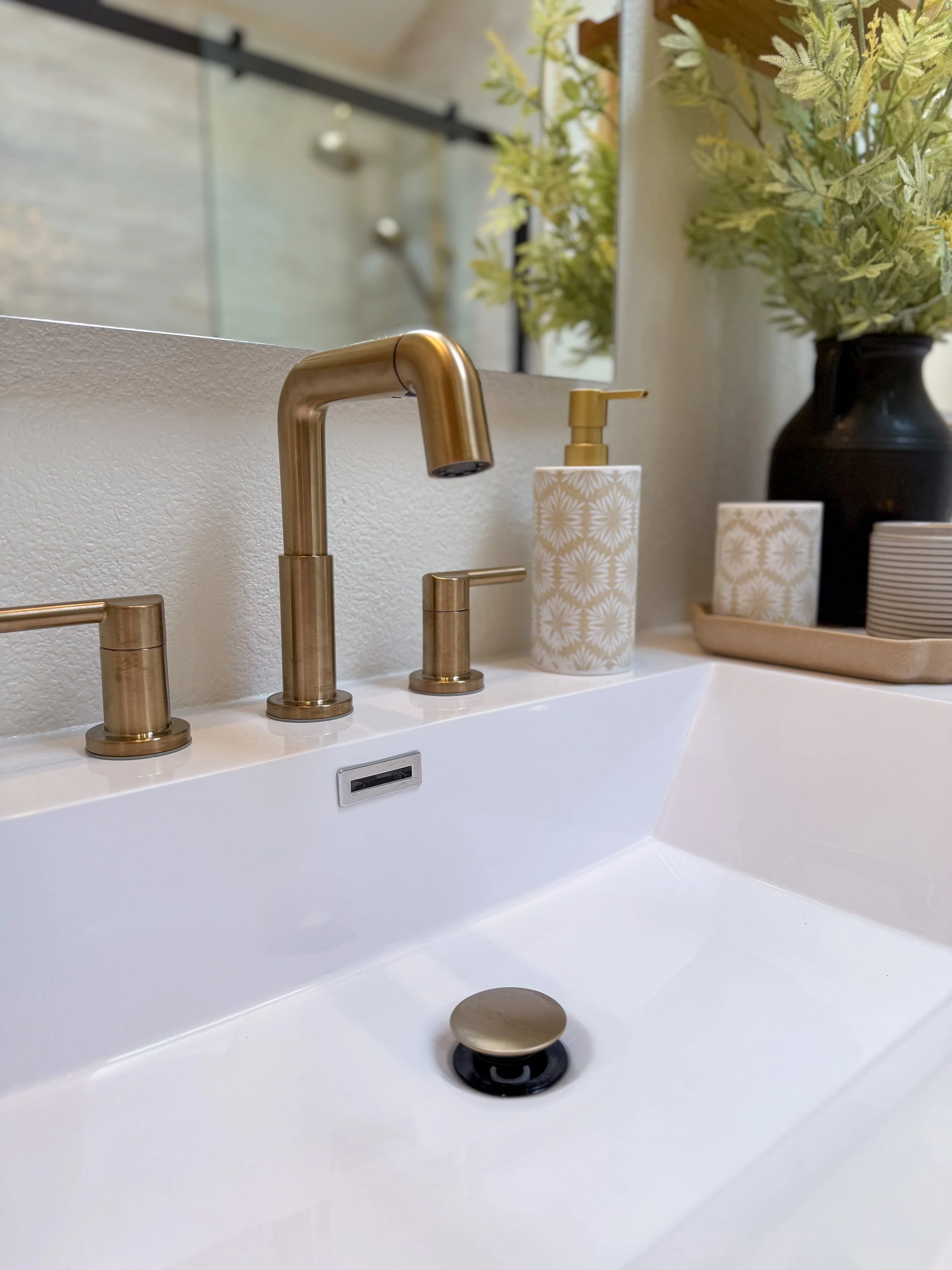 primary bathroom remodel, earthy bathroom inspiration, shower and bathtub combo, shower system with handheld sprayer, double vanity, wood vanity, floating shelves, arched medicine cabinets, toilet paper niche, double light sconce, brass finishes