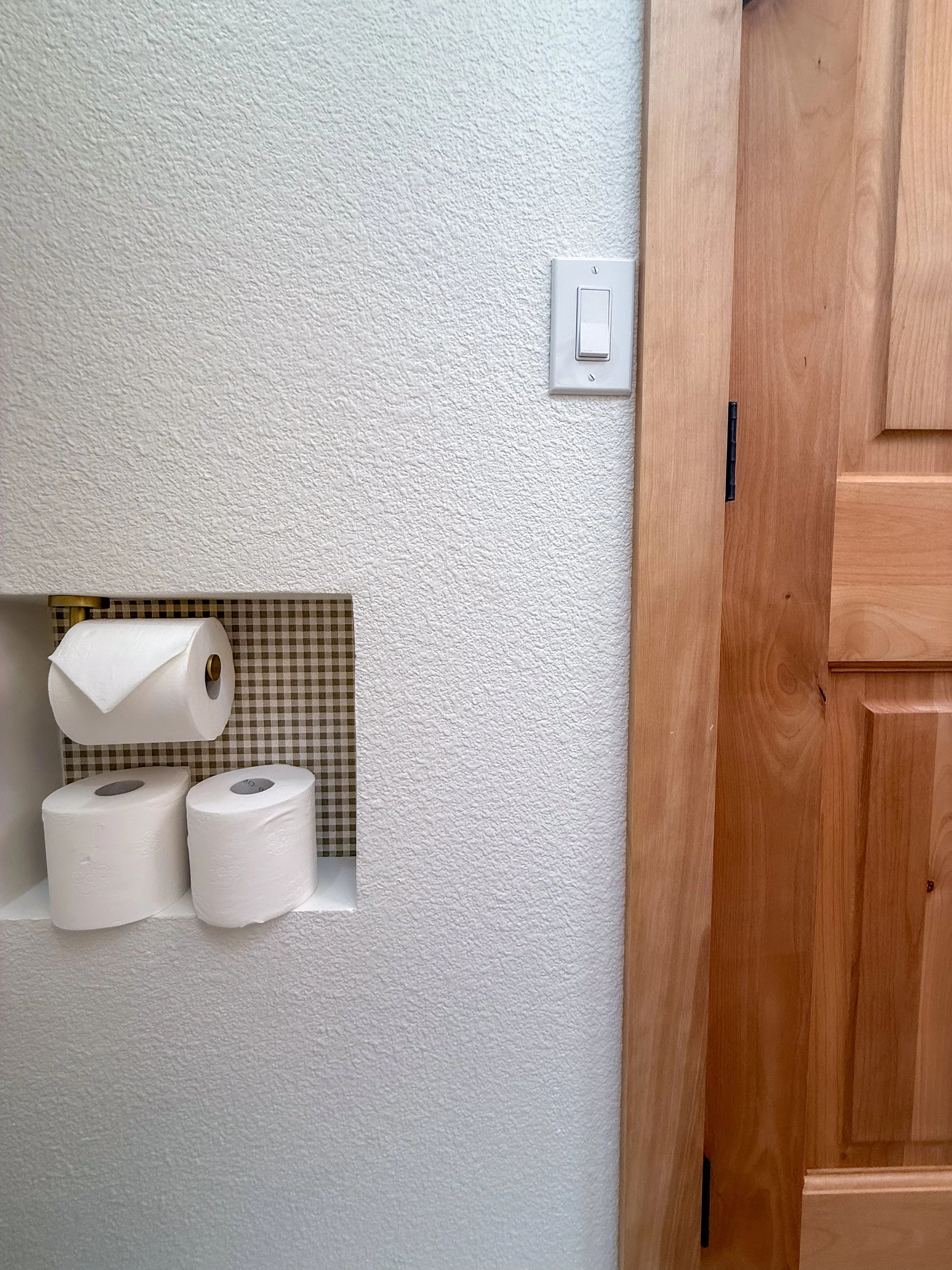 primary bathroom remodel, earthy bathroom inspiration, shower and bathtub combo, shower system with handheld sprayer, double vanity, wood vanity, floating shelves, arched medicine cabinets, toilet paper niche, double light sconce, brass finishes