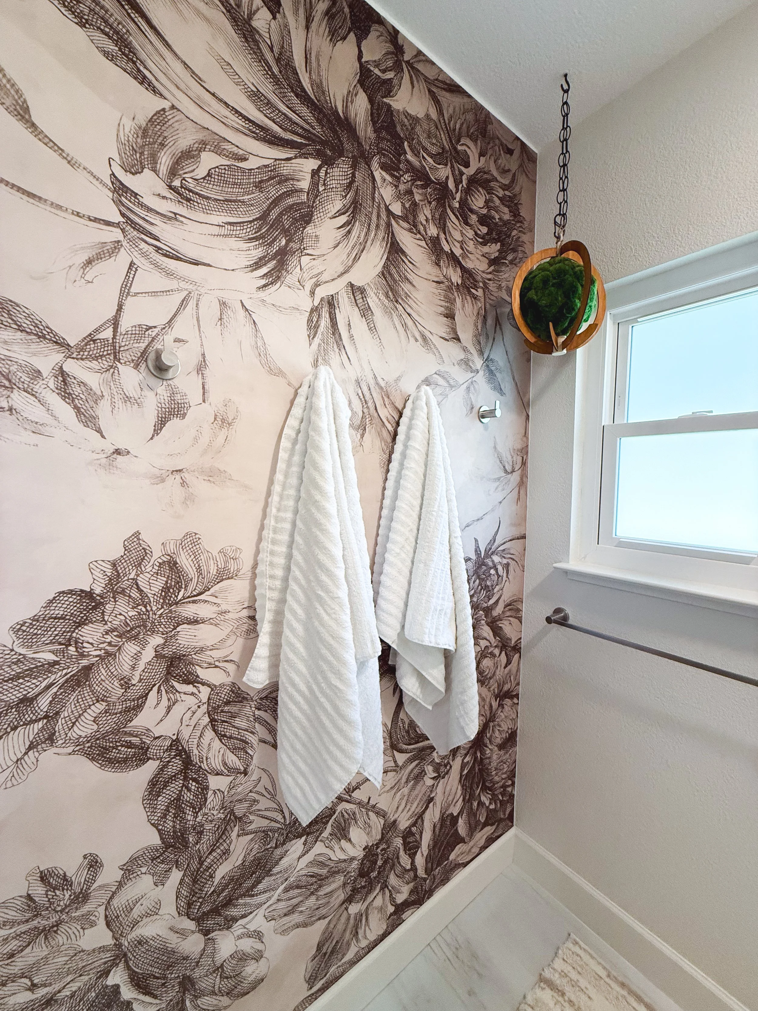 bathroom remodel, contemporary, renovation, vanity, single sink vanity, pendant lighting, hanging lighting, contemporary mirror, bathroom wall removal, brushed nickel, hardware mix, black hardware, bathroom decor, flower tile, wallpaper, bold