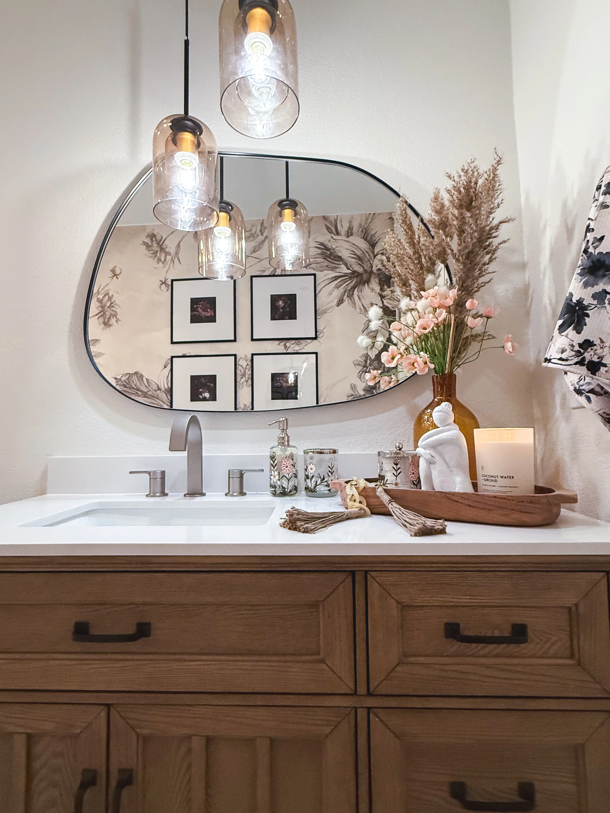 bathroom remodel, contemporary, renovation, vanity, single sink vanity, pendant lighting, hanging lighting, contemporary mirror, bathroom wall removal, brushed nickel, hardware mix, black hardware, bathroom decor, flower tile, wallpaper, bold