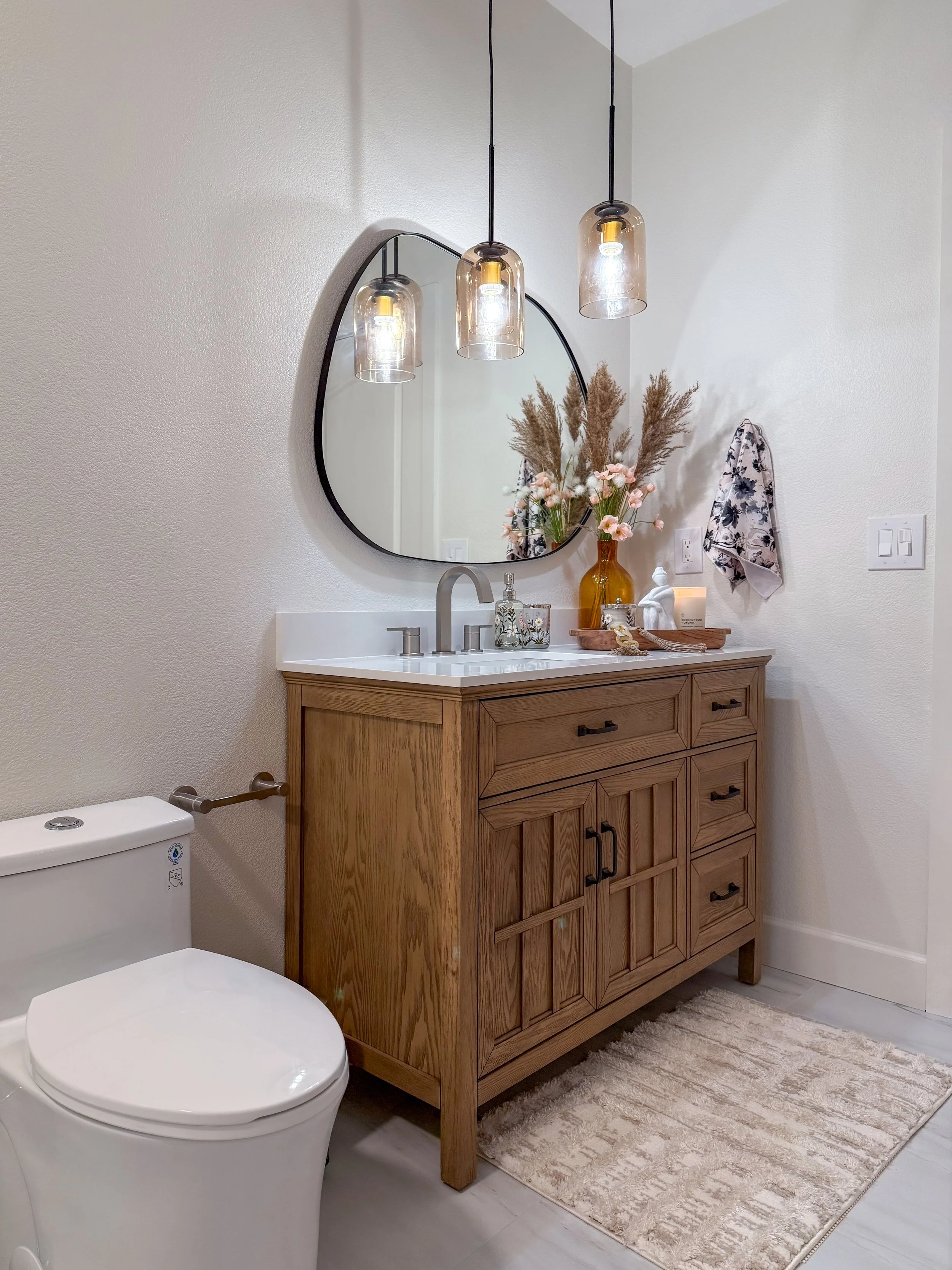 bathroom remodel, contemporary, renovation, vanity, single sink vanity, pendant lighting, hanging lighting, contemporary mirror, bathroom wall removal, brushed nickel, hardware mix, black hardware, bathroom decor, flower tile, wallpaper, bold