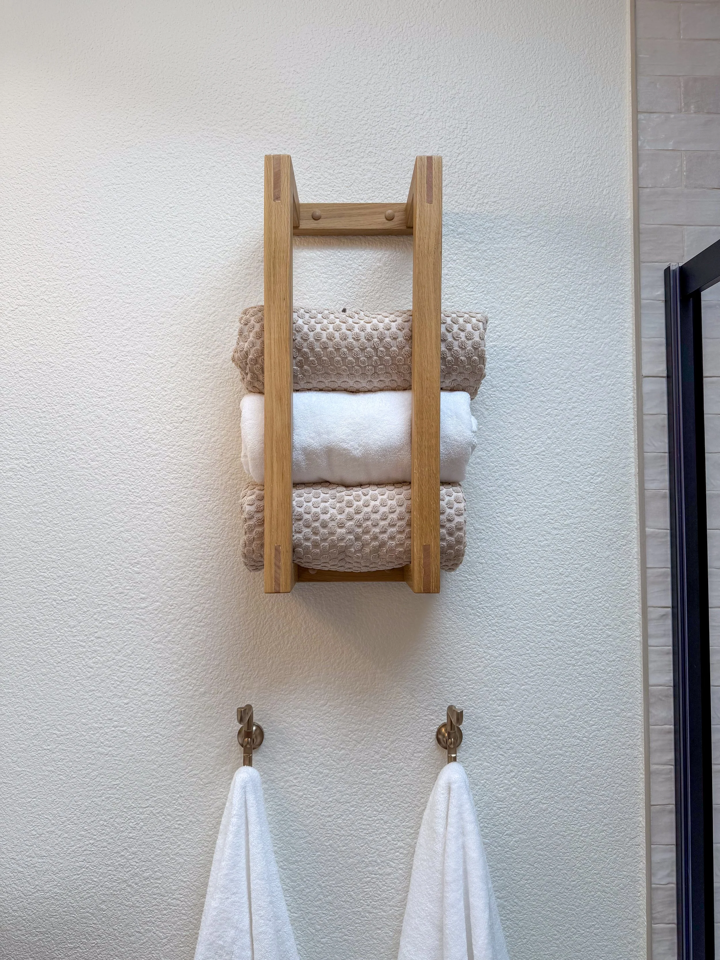 primary bathroom remodel, earthy bathroom inspiration, shower and bathtub combo, shower system with handheld sprayer, double vanity, wood vanity, floating shelves, arched medicine cabinets, toilet paper niche, double light sconce, brass finishes