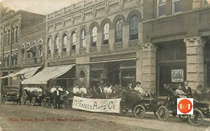 Postcard view of McFadden Auto Co., showing off their cars along Main Street, ca. 1910