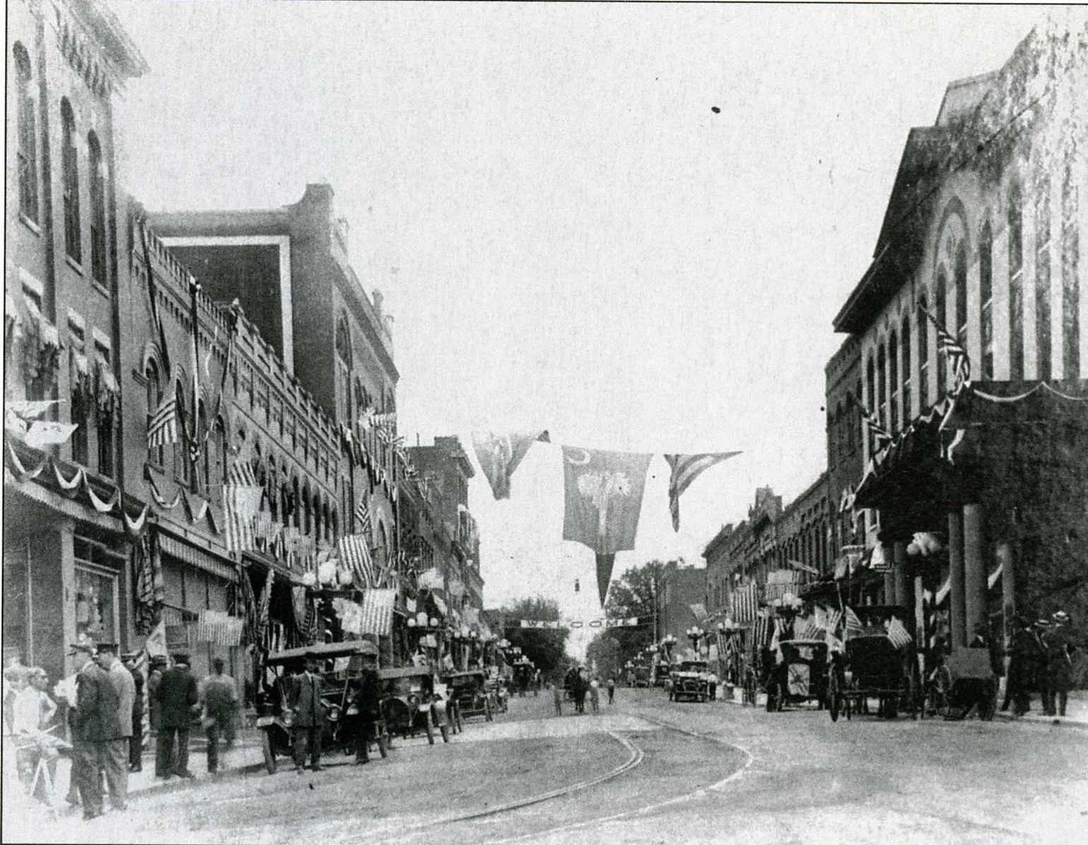 Ca. 1910 image of downtown Rock Hill looking east. Note the early cars as well as the trolley tracks which turned from Main Street onto North Trade Street.