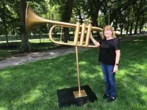 Local fan, Mary, poses with the found trombone
