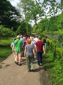 Community Steward Jaclyn Peterson leads a pre-workday nature walk to introduce volunteers to native species around the Humboldt Park lagoon
