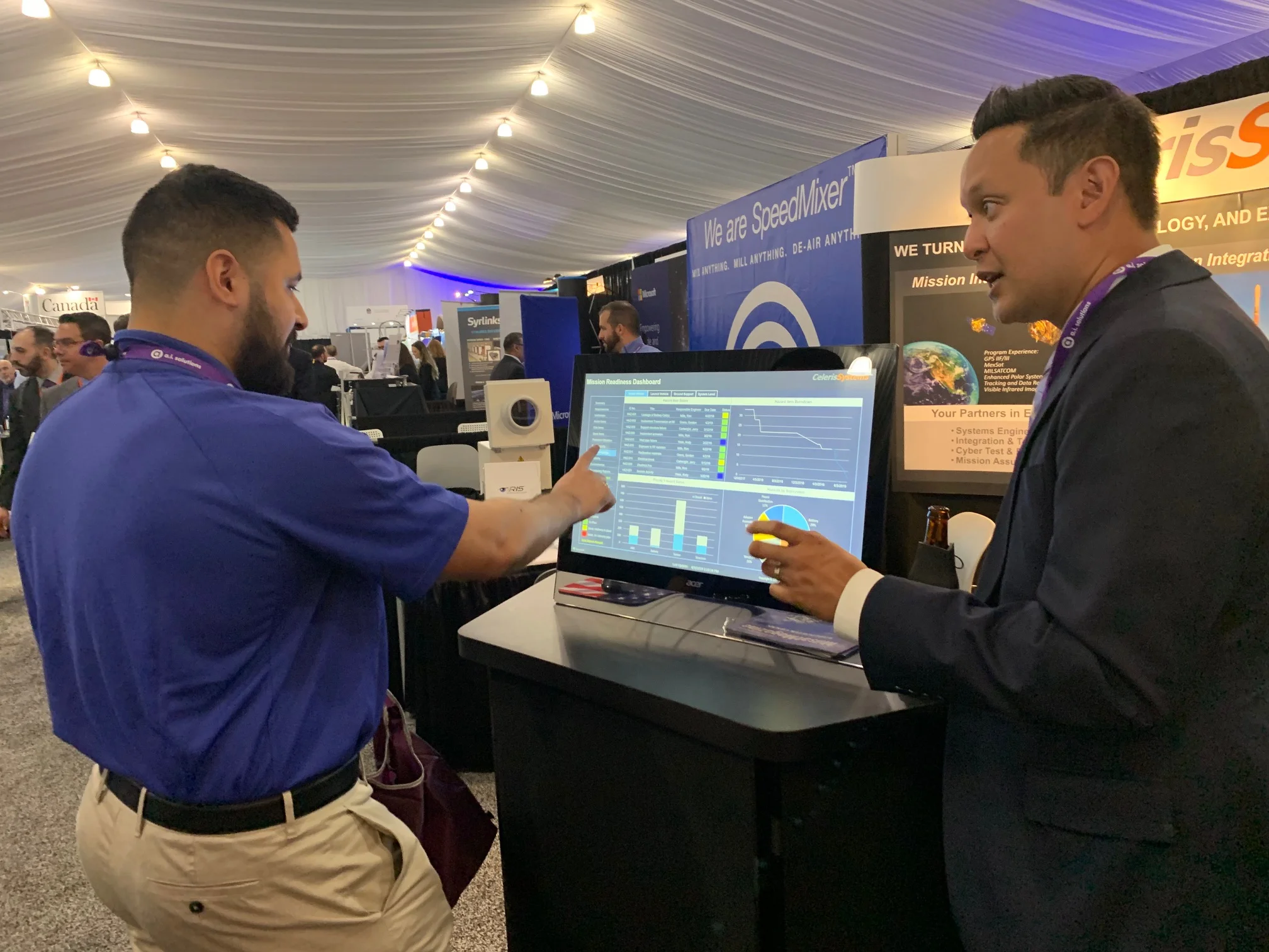 Celeris Systems Vice President Rob Enrico shares iRIS® touchscreen dashboard capability with a symposium attendee.