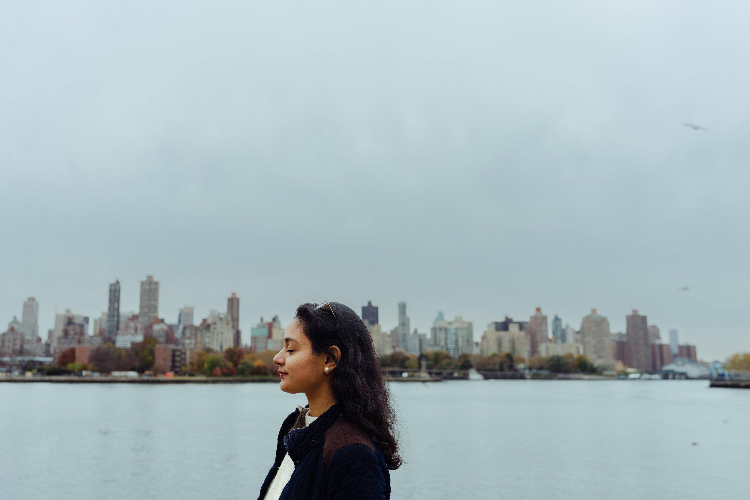 Dipali Gupta on the shore of the East River