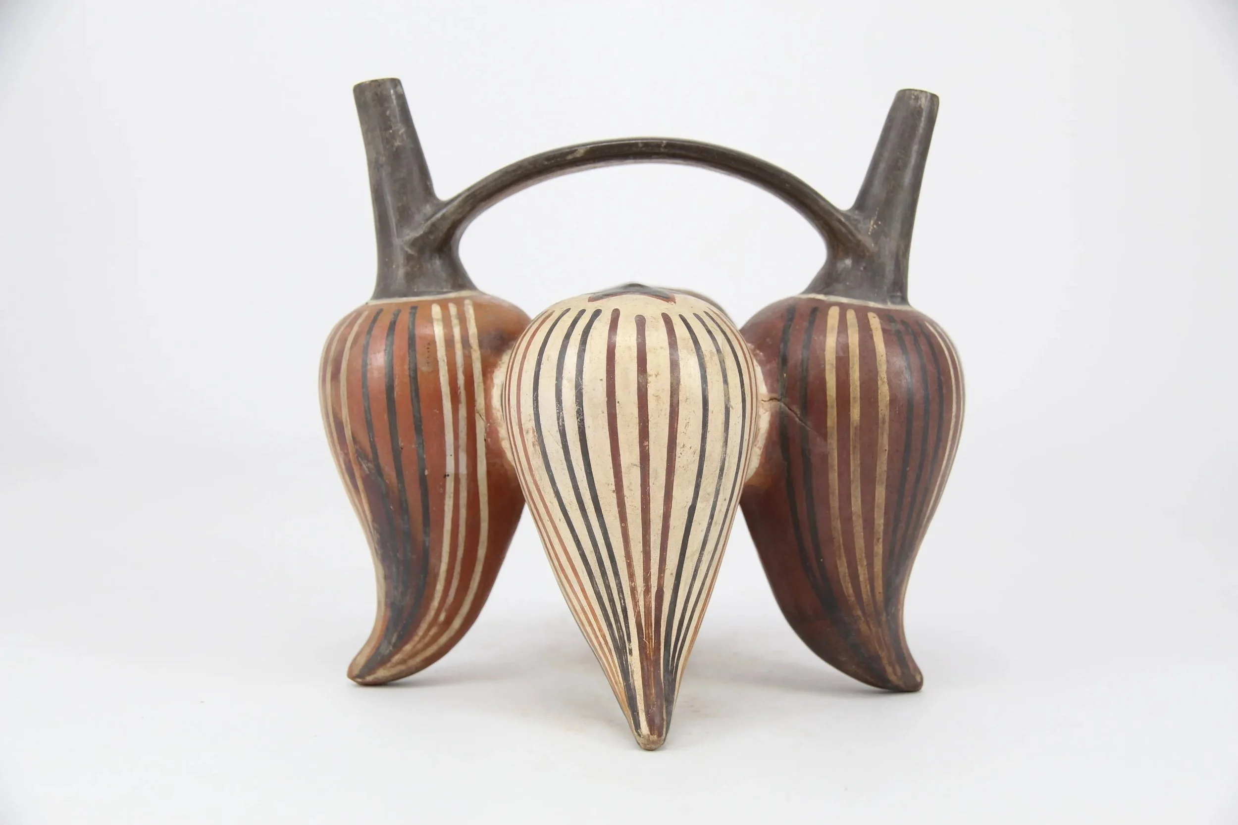 Nasca ceramic double-spout bridge-handle bottle from the South Coast of Peru.