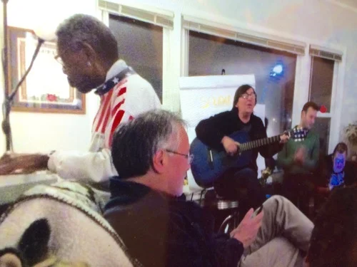 Laurie and Elbert lead the singing at L'Arche Chicago community night