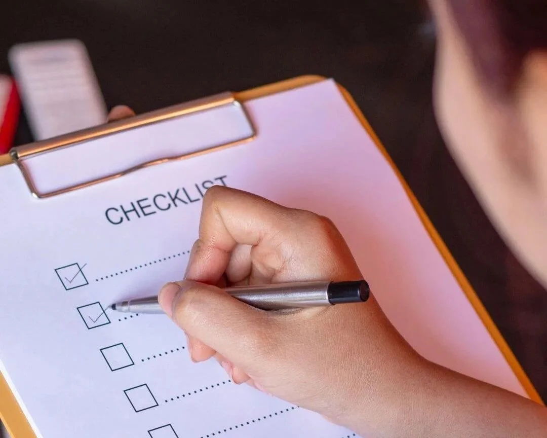 Woman checking off items on her to-do list for productivity.