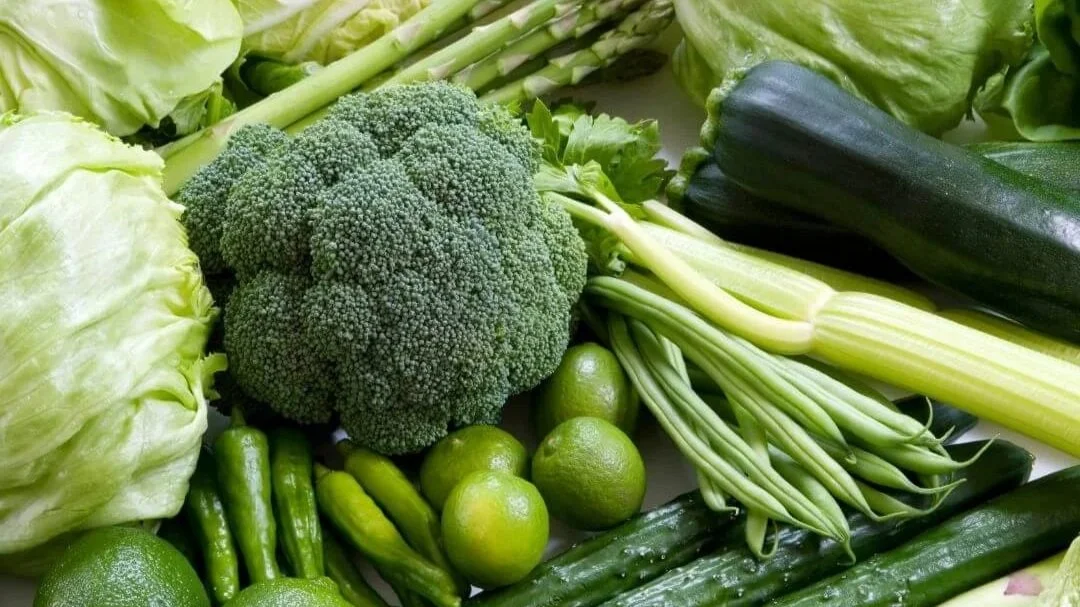 Green veggies laid out on a table.
