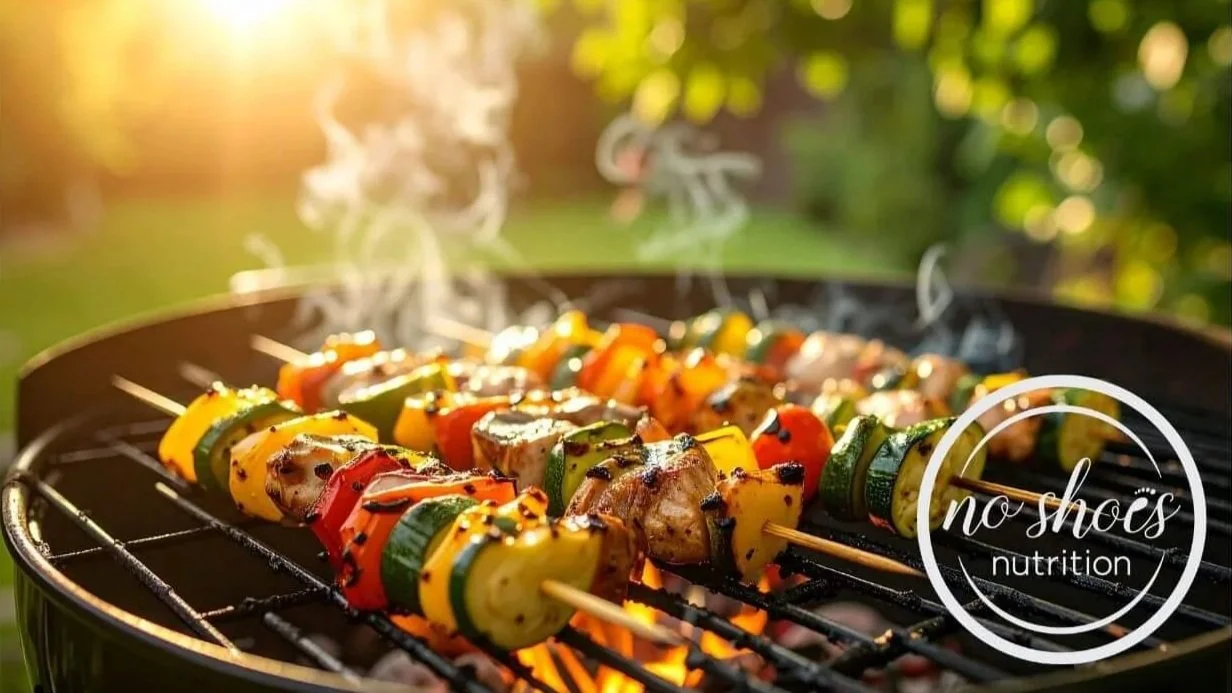 Veggies on skewers on an open grill.