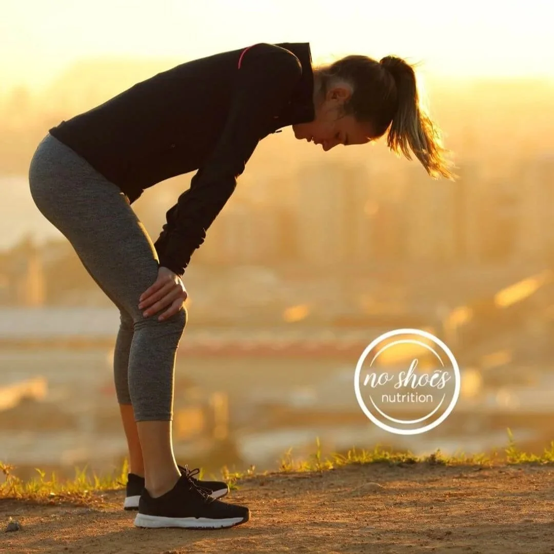 A woman bent over with exhaustion that has nothing to do with sleep.