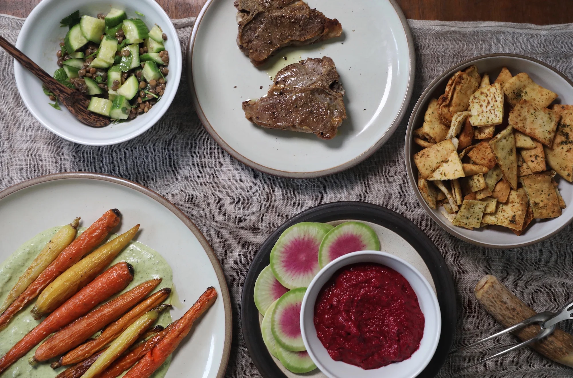 A peek at the little Middle Eastern inspired dinner spread I made, including a take on Israeli salad, roasted carrots on a labneh zhoug sauce, roasted lamb, and roasted beet and garlic dip. 