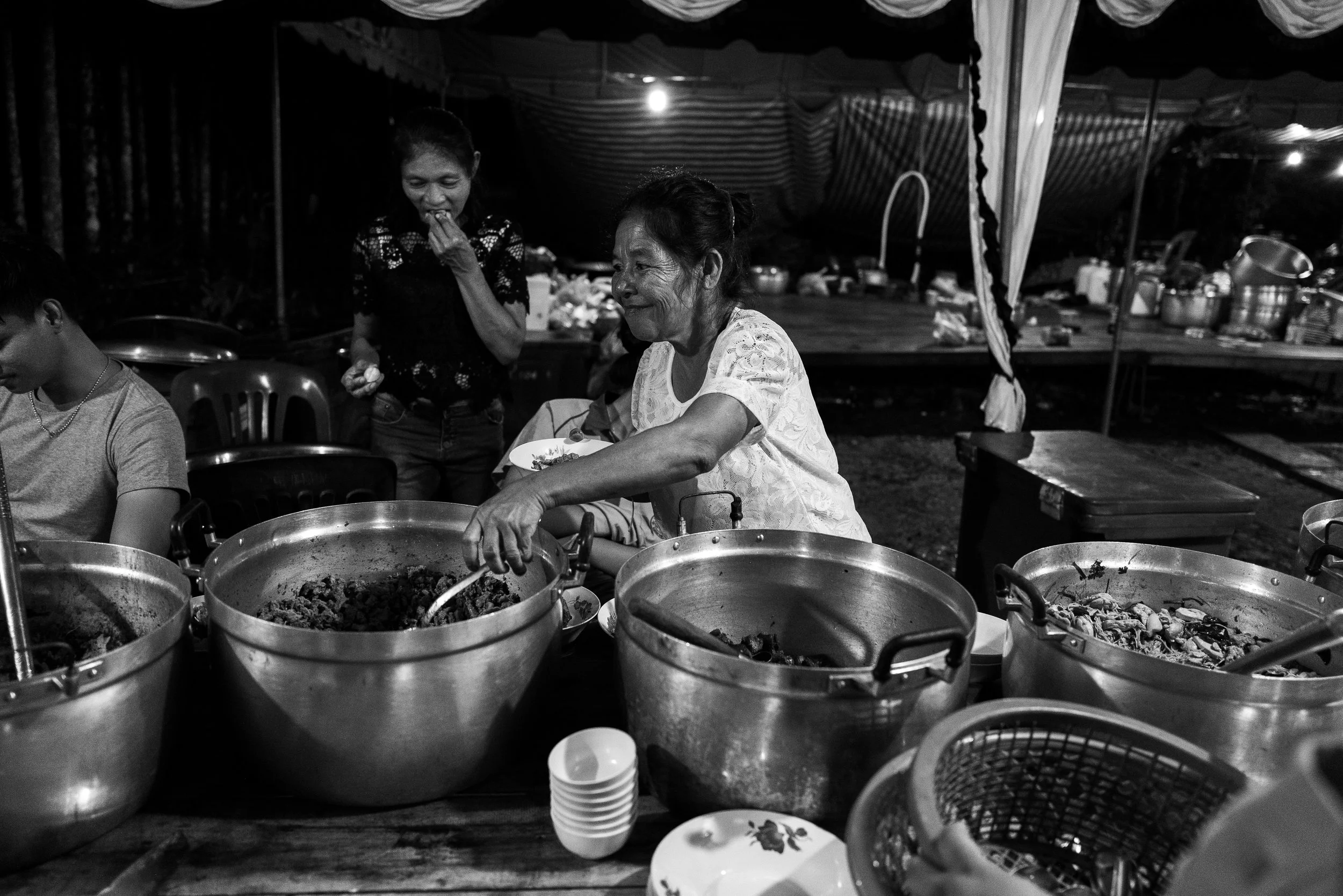 Tim’s mother serving dishes to the guests with a beautiful smile