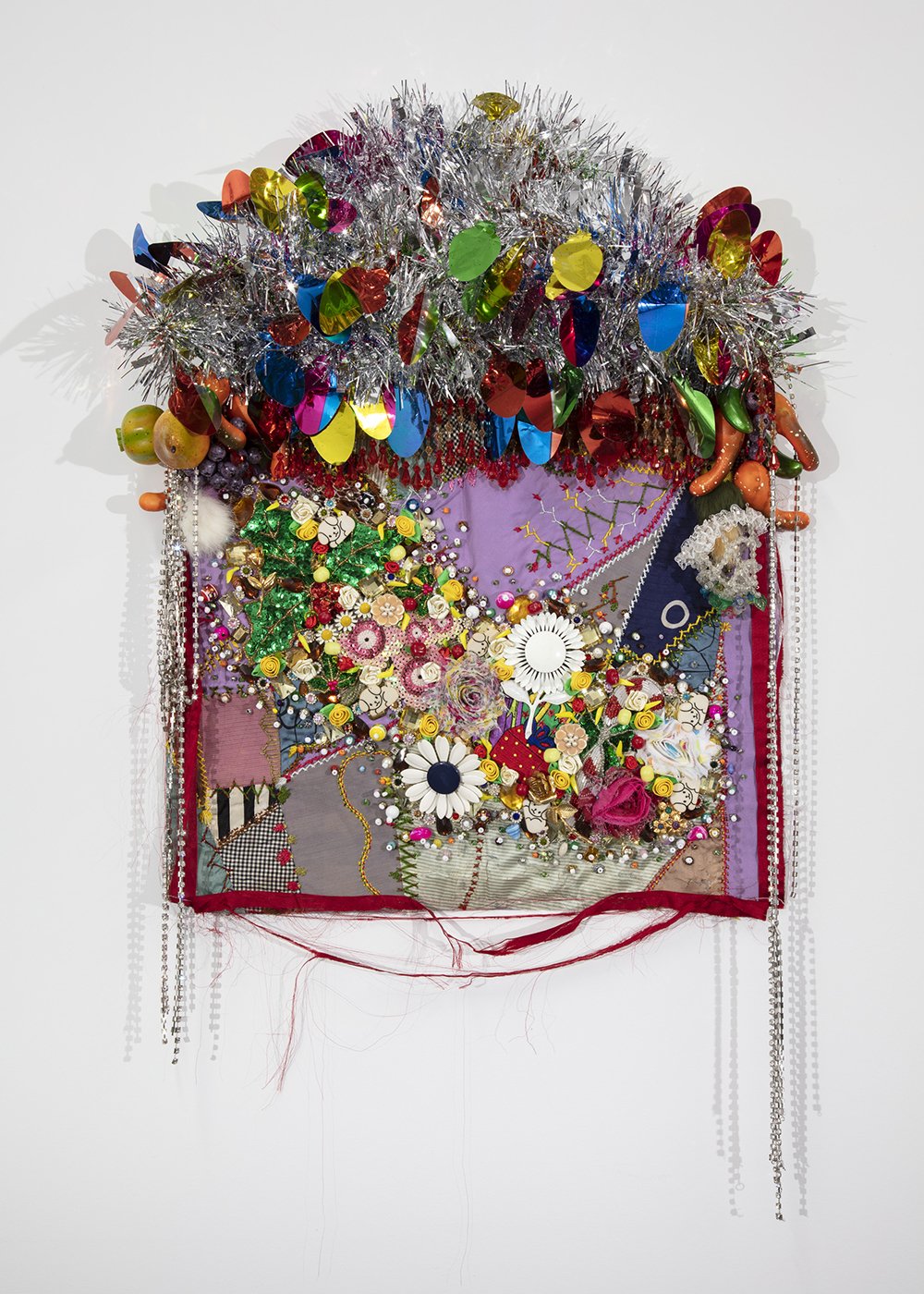   Shroud #3 (study),  2022, Found ‘Crazy’ quilt ca. 1900, trim, fabric flowers, garland, costume jewelry, buttons, plastic flowers and fruit, beads, sequins, thread, fabric, pine, 33 x 21 x 5” 