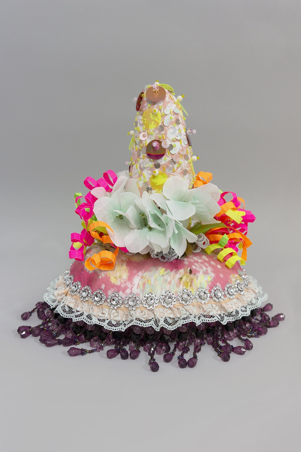   Untitled,  2022, Crystal and plastic beads and sequins, found fabric, trim, fabric flowers, ribbon, beaded flowers, polyester batting, thread, 10 x 11 x 9” 