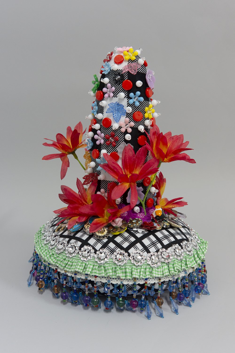   Untitled,  2022, Crystal and plastic beads and sequins, found fabric, trim, fabric flowers, costume jewelry, polyester batting, thread, 10 x 8 x 8” 