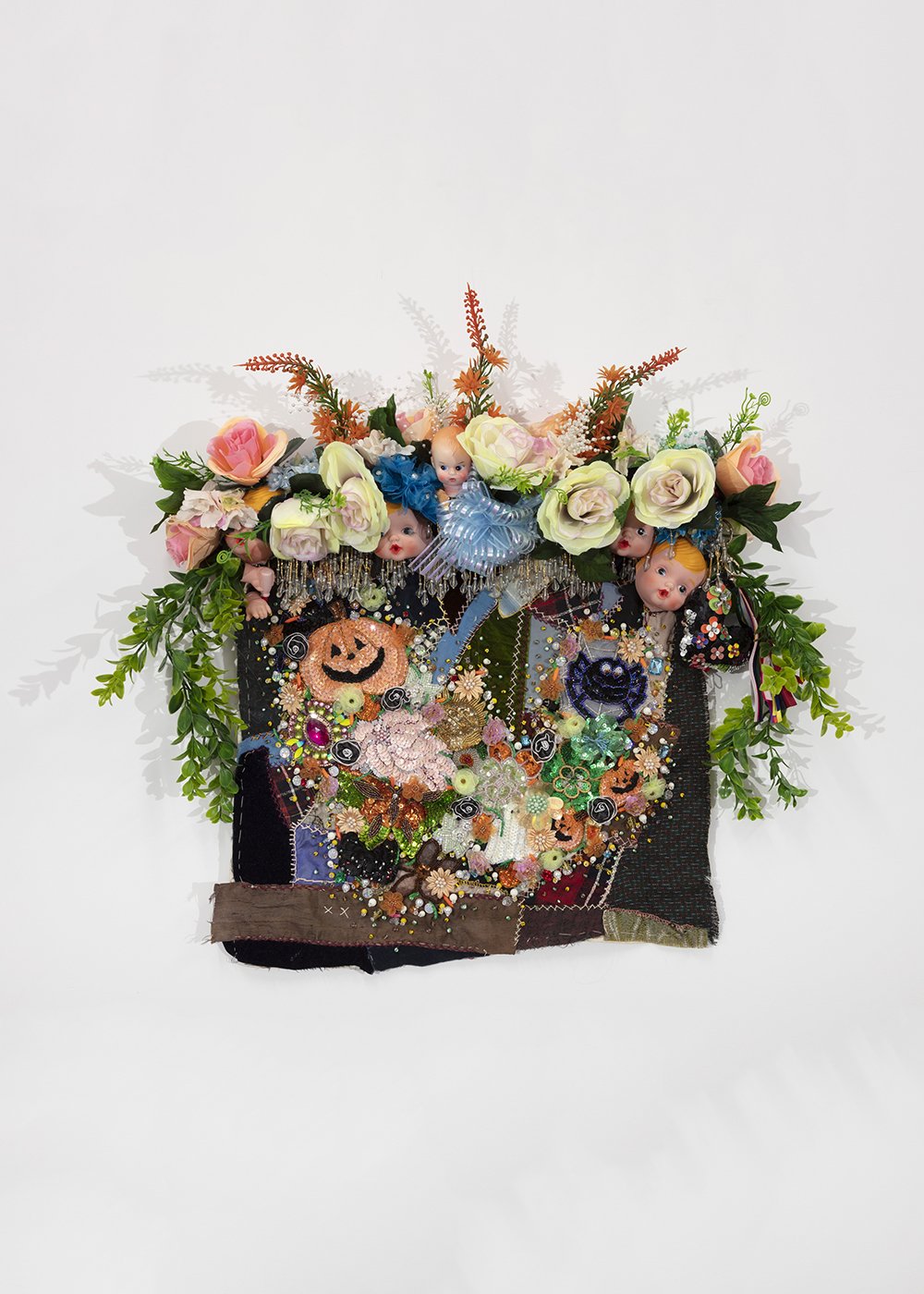   Shroud #6 (study),  2022, Found ‘Crazy’ quilt ca. 1900, trim, fabric flowers, garland, dolls, costume jewelry, buttons, plastic flowers and fauna, beads, sequins, thread, fabric, pine, 27 x 28 x 5” 