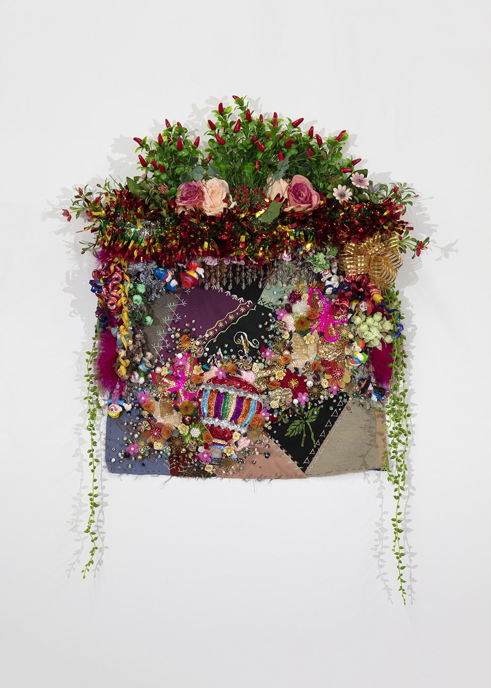  Shroud #4 (study),  2022, Found ‘Crazy’ quilt ca. 1900, trim, fabric flowers, garland, toys, costume jewelry, buttons, plastic flowers and fauna, beads, sequins, thread, fabric, pine, 36 x 26 x 6” 