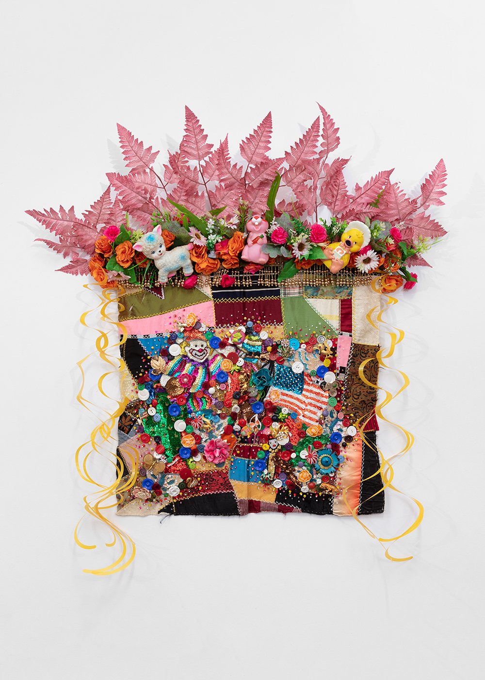   Shroud #9 (study) , 2022, Found ‘Crazy’ quilt ca. 1900, trim, fabric flowers, streamers, toys, costume jewelry, buttons, plastic flowers, beads, sequins, thread, fabric, pine, 39 x 36 x 7” 