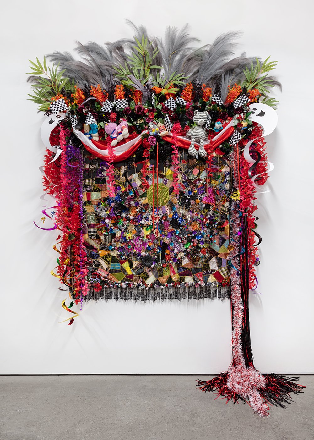   Shroud #11 , 2022, Found ‘Crazy’ quilt ca. 1898, trim, fabric flowers, streamers, banners, garland, metal chain, toys, ribbon, plastic jewelry, buttons, plastic flowers and fauna, beads, thread, fabric, Douglas fir, 120 x 90 x 24” 