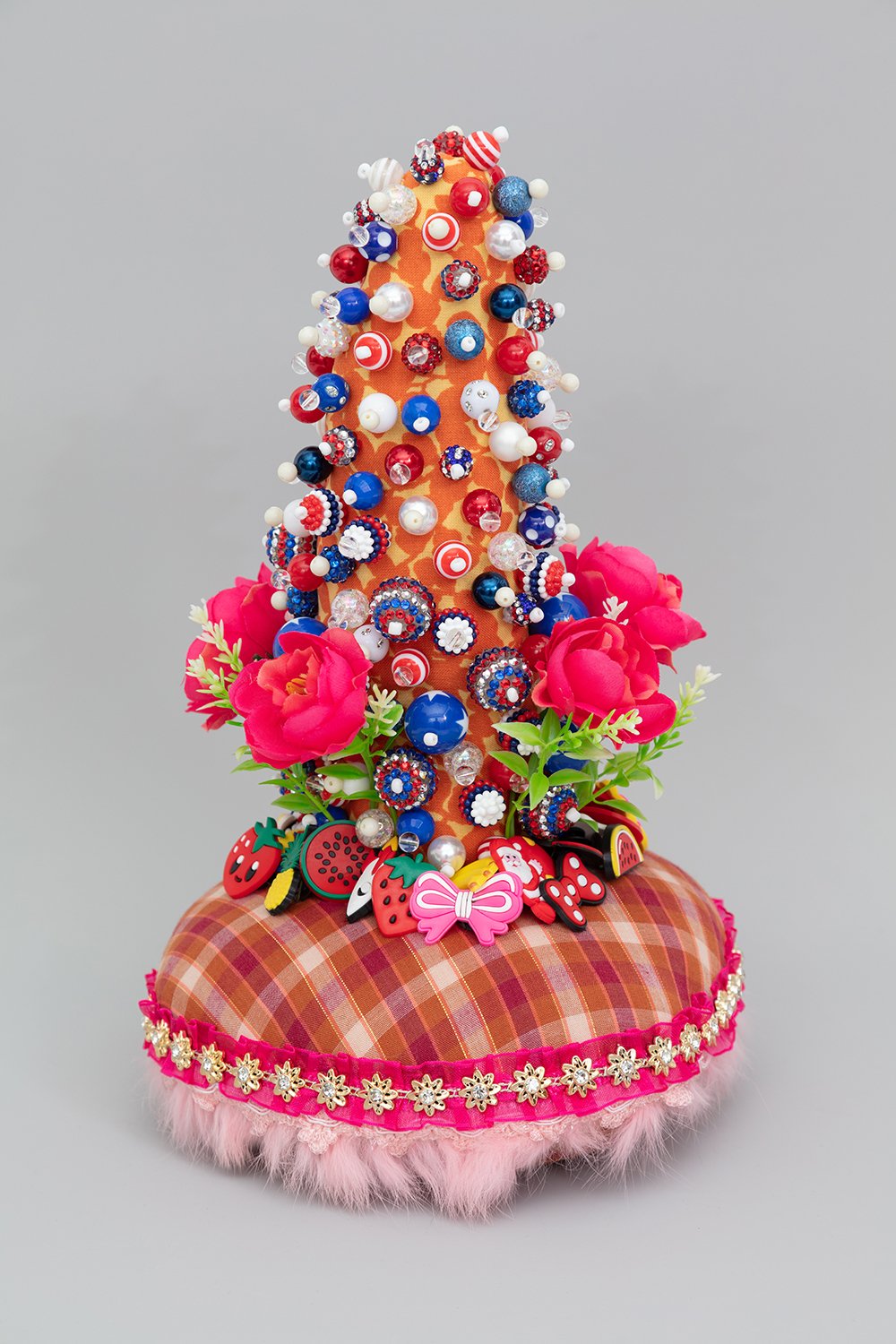   Untitled , 2022, Plastic beads, found fabric, trim, charms, fabric and plastic flowers, polyester batting, thread, 12.5 x 8.5 x 8.5” 